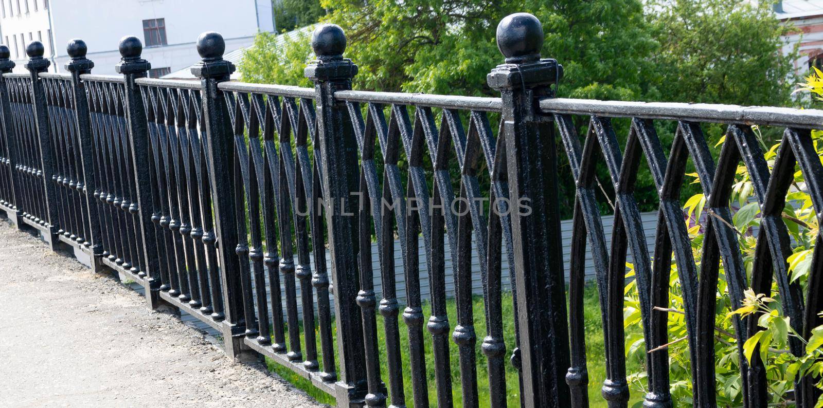 Black forged fence on a granite base.
