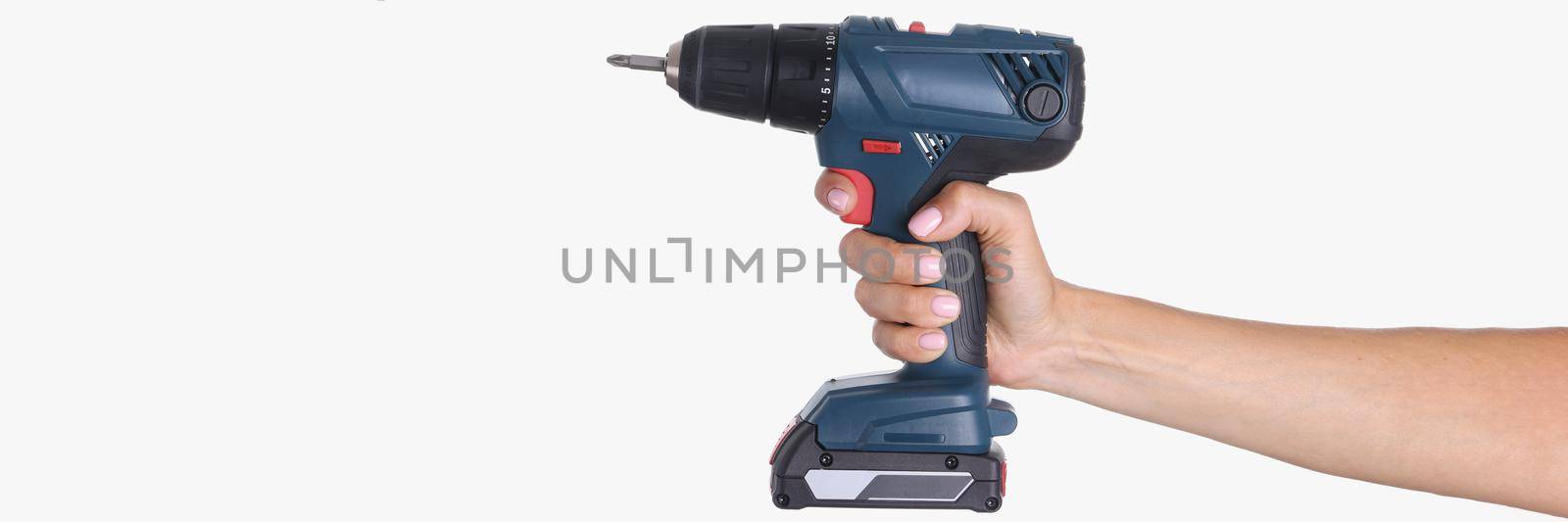 Close-up of woman hand holding electric cordless drill, foreman equipment for work, tool for repair and fix things, screw gun. Construction renovation instrument, screwdriver concept