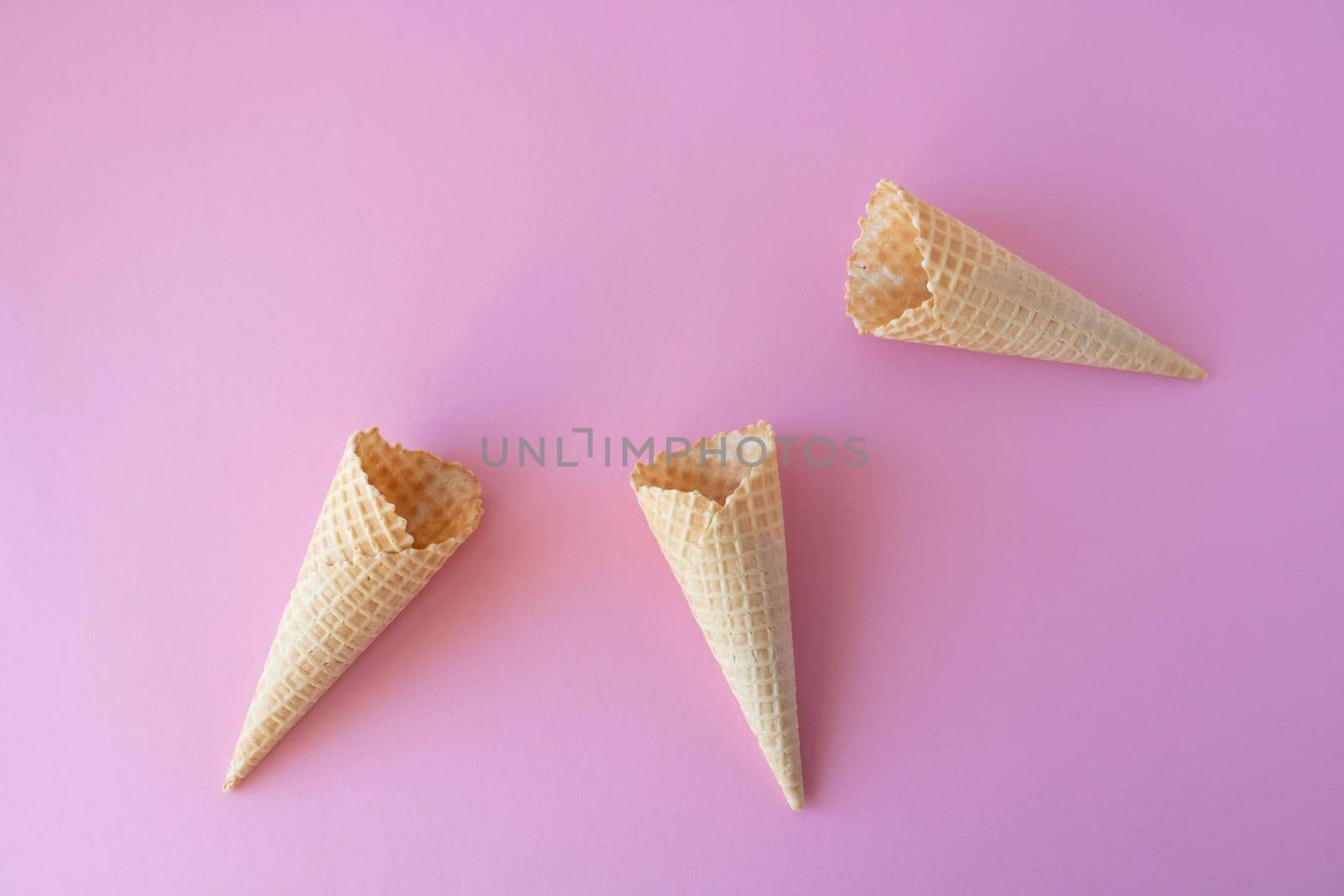 Creative photo of empty waffle cones on a pink background