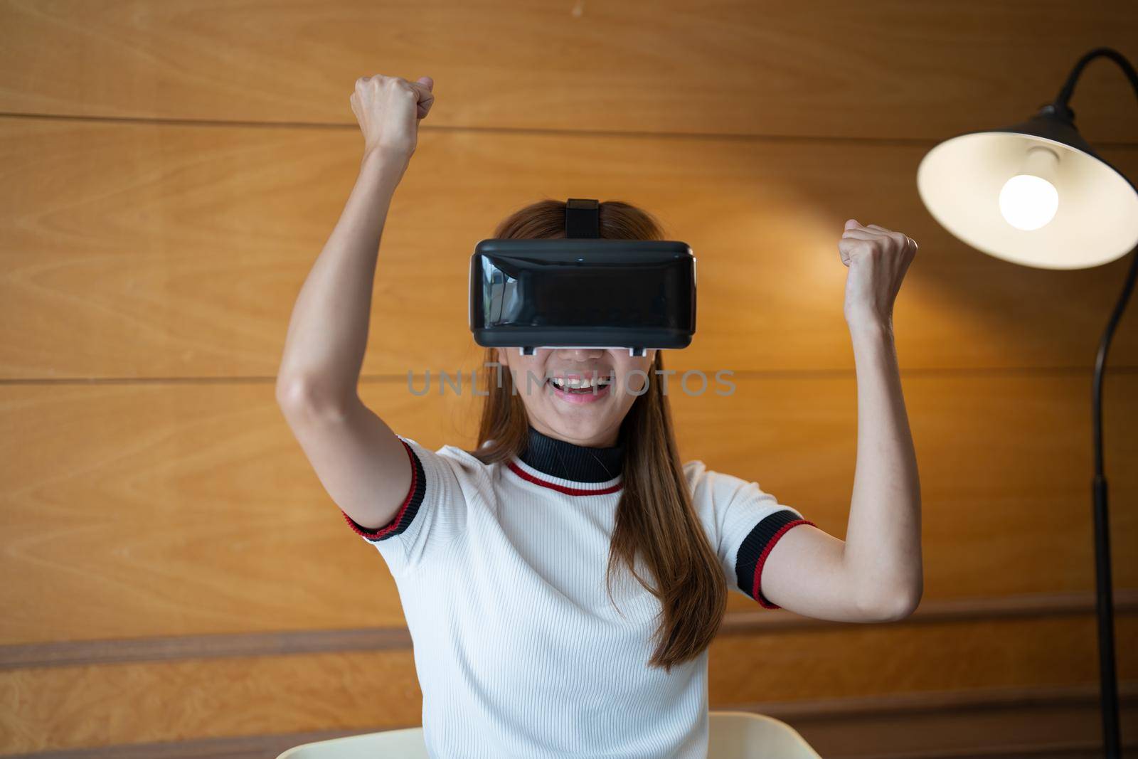 Photo of young asian woman cheerful guy have fun celebrate victory win game goggles ay her home.
