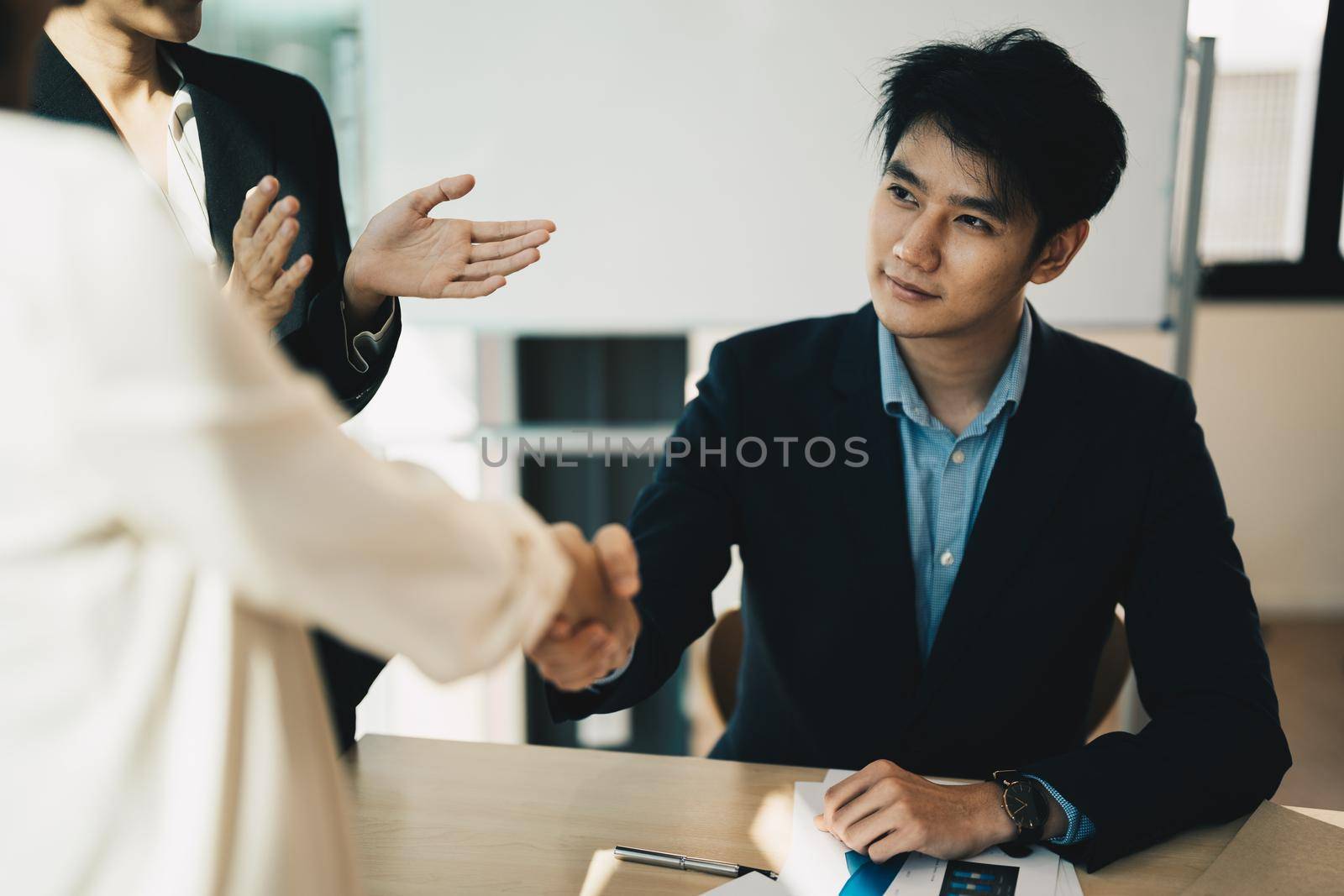 Partnership. asian business people shaking hand after business job interview in meeting room at office, congratulation, investor, success, interview, partnership, teamwork, financial, concept by nateemee
