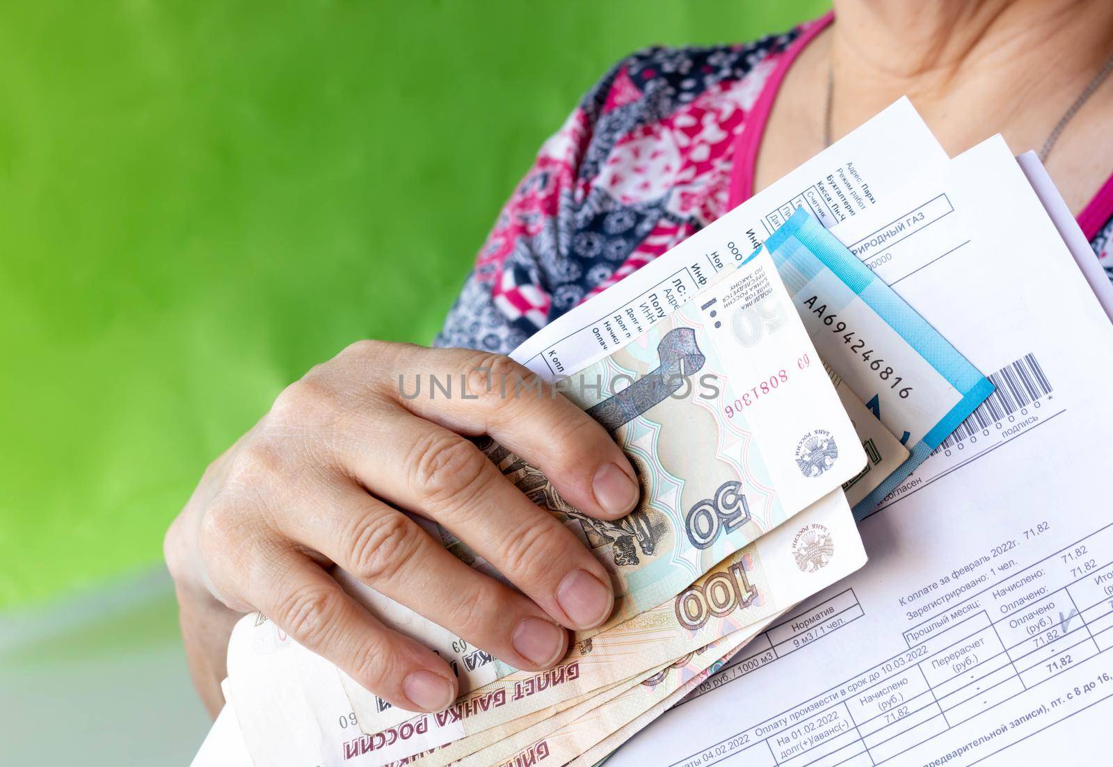 The hand holds Russian banknotes and receipts by lapushka62