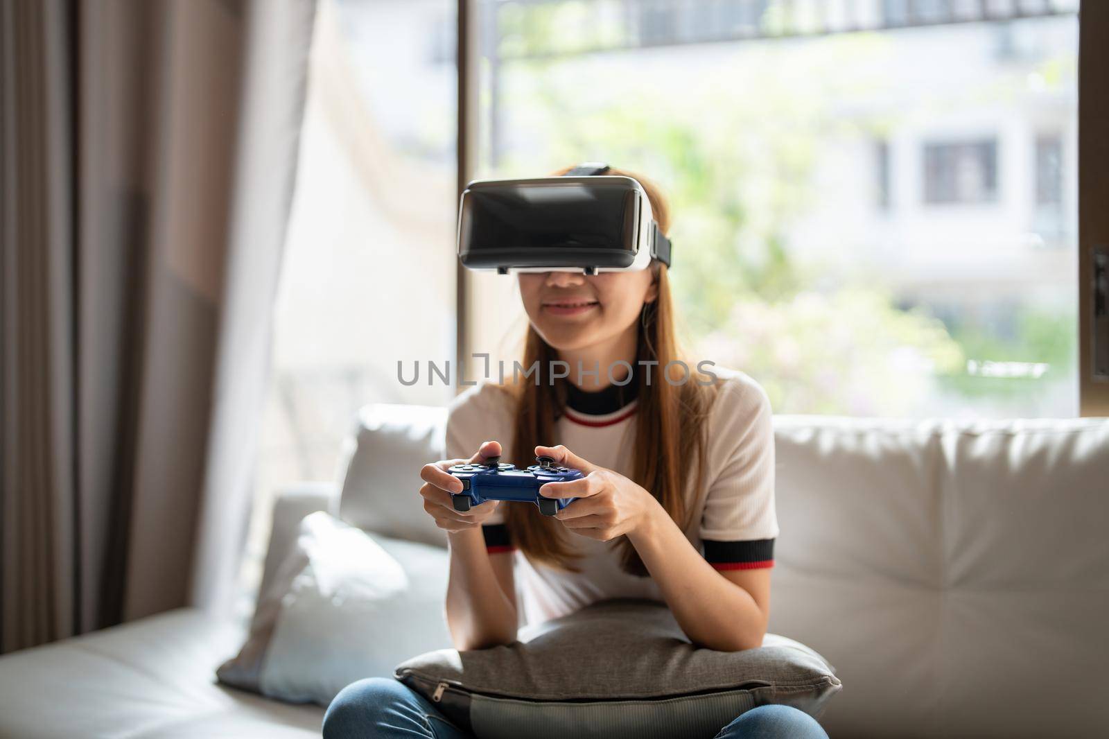 close up happy emotion asian woman playing video games with controller on abstract background toned with virtual glasses.