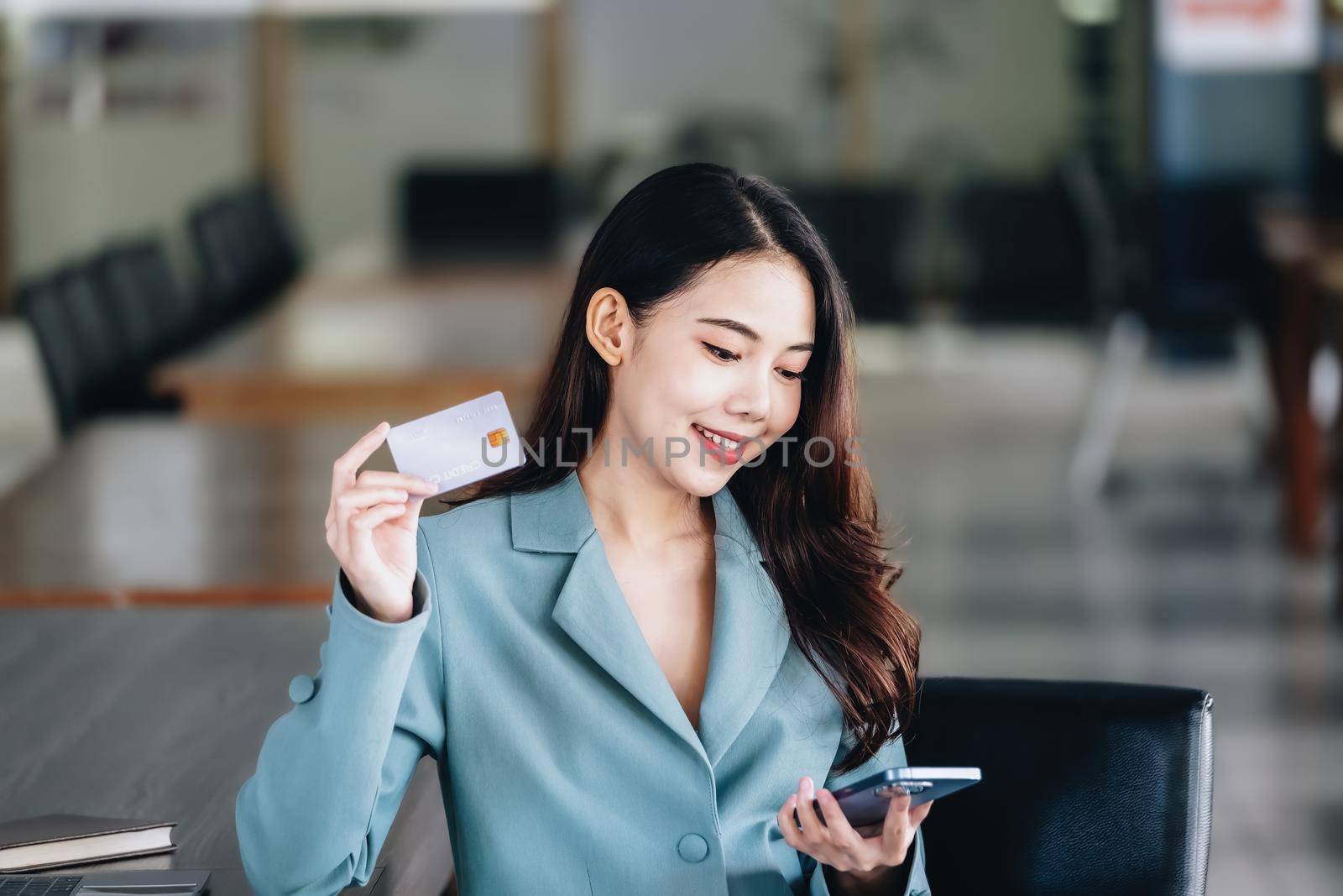 Online Shopping and Internet Payments, Beautiful Asian women are using their credit cards and mobile phones to shop online or conduct errands in the digital world. by Manastrong