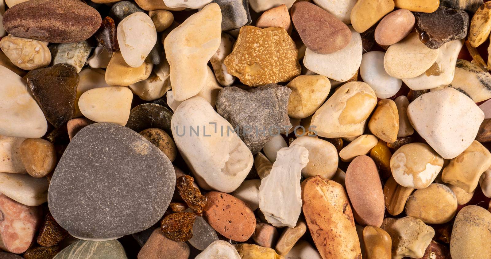 close up of colored sea pebbles. top view. color by lempro