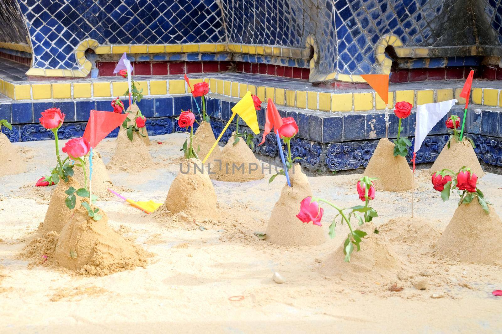 Group of sand pagoda on temple in Songkran Festival, Sand Pagoda is an ancient tradition of the ancient people. And these sand pagodas are also decorated with flags and flowers