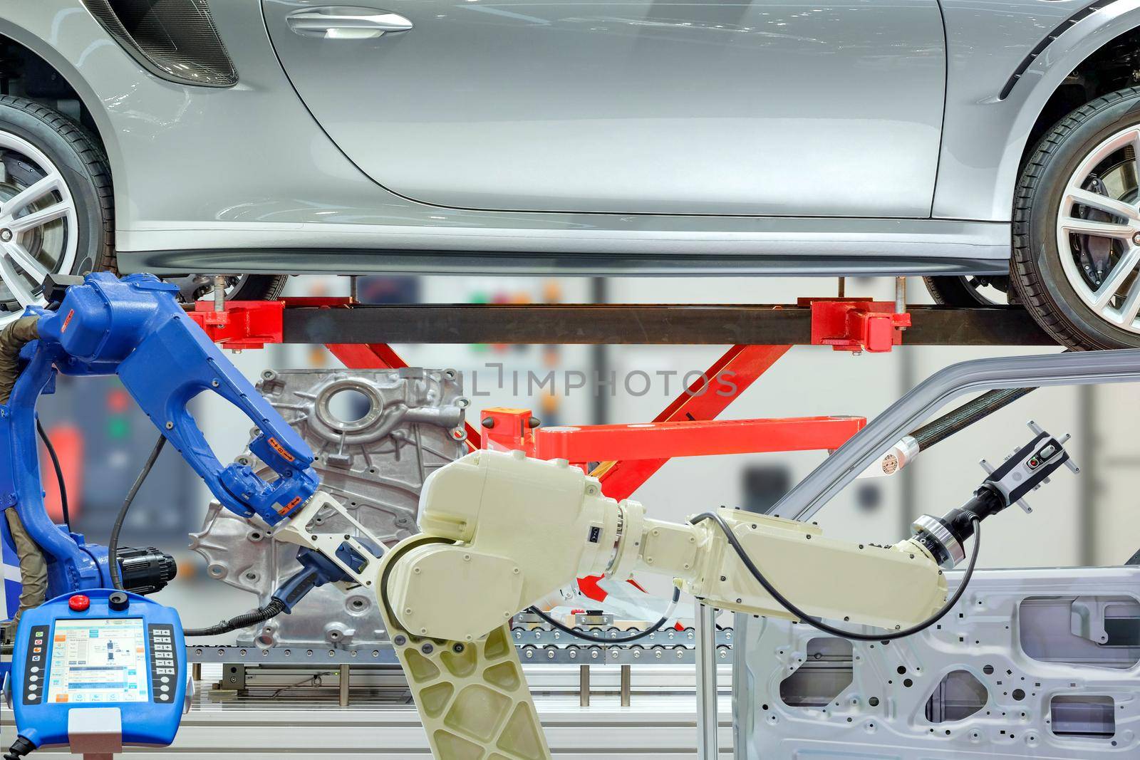 Industrial robotic installed 3D scan device to scanning auto parts for measuring data with remote for setting program for work automation on blurred control panel background, industry 4.0 concept
