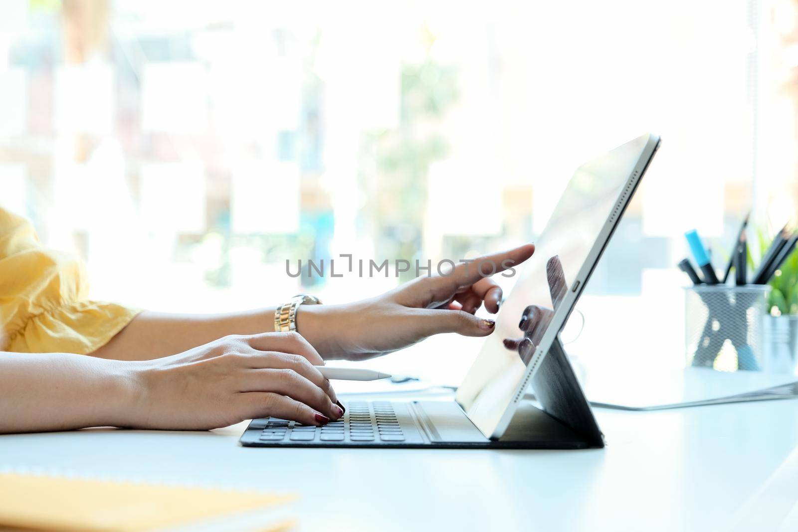 Woman using laptop computer for business financial by nateemee