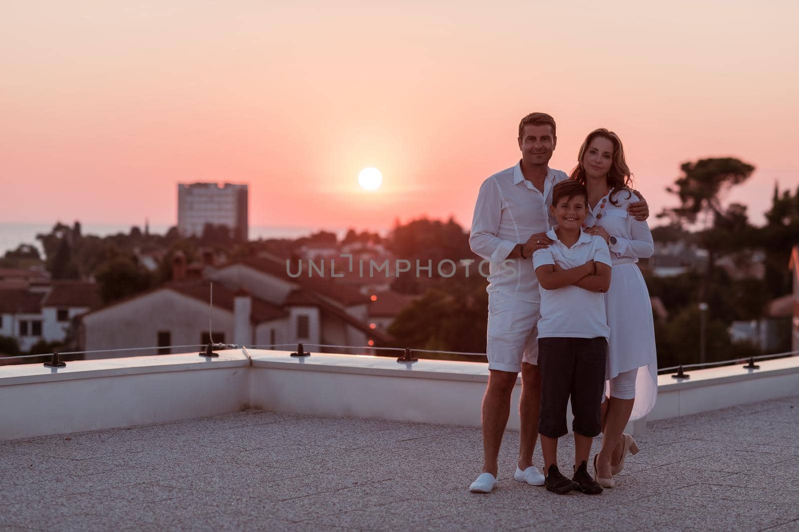 The happy family enjoys and spends time together on the roof of the house. Selective focus. High-quality photo