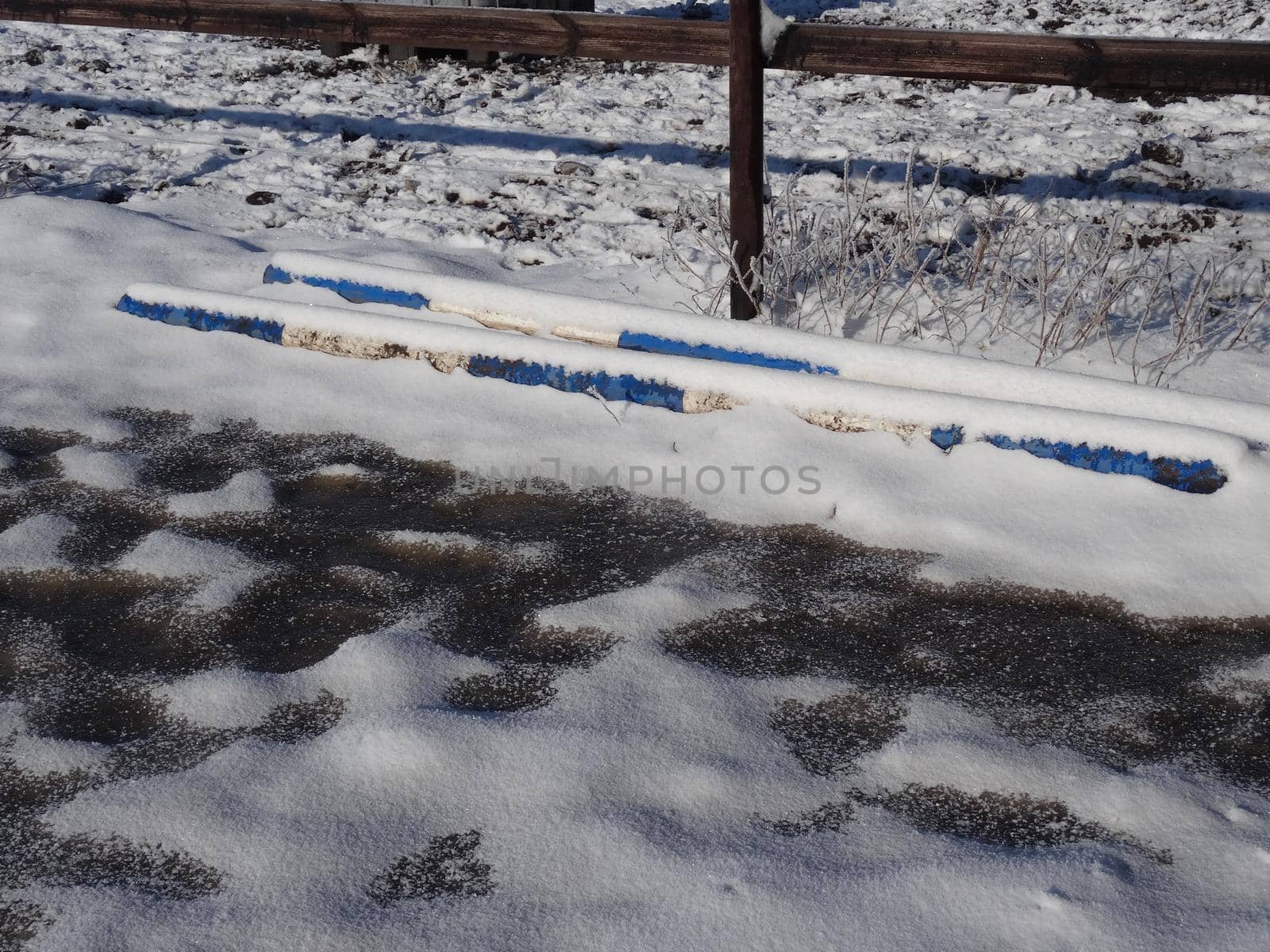 Blue and white obstacle bars covered with snow by Luise123