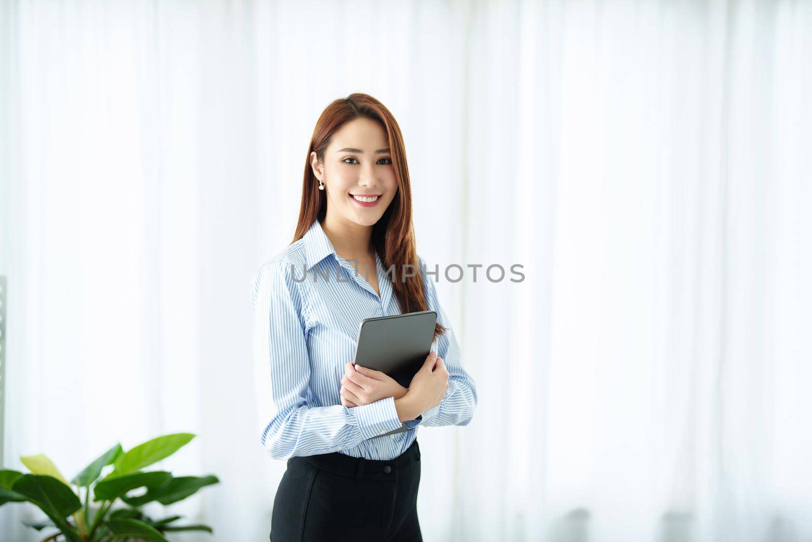 Entrepreneur, Business Owner, Accountant, Portrait of Starting small businesses Asians holding a smiling tablet in the office