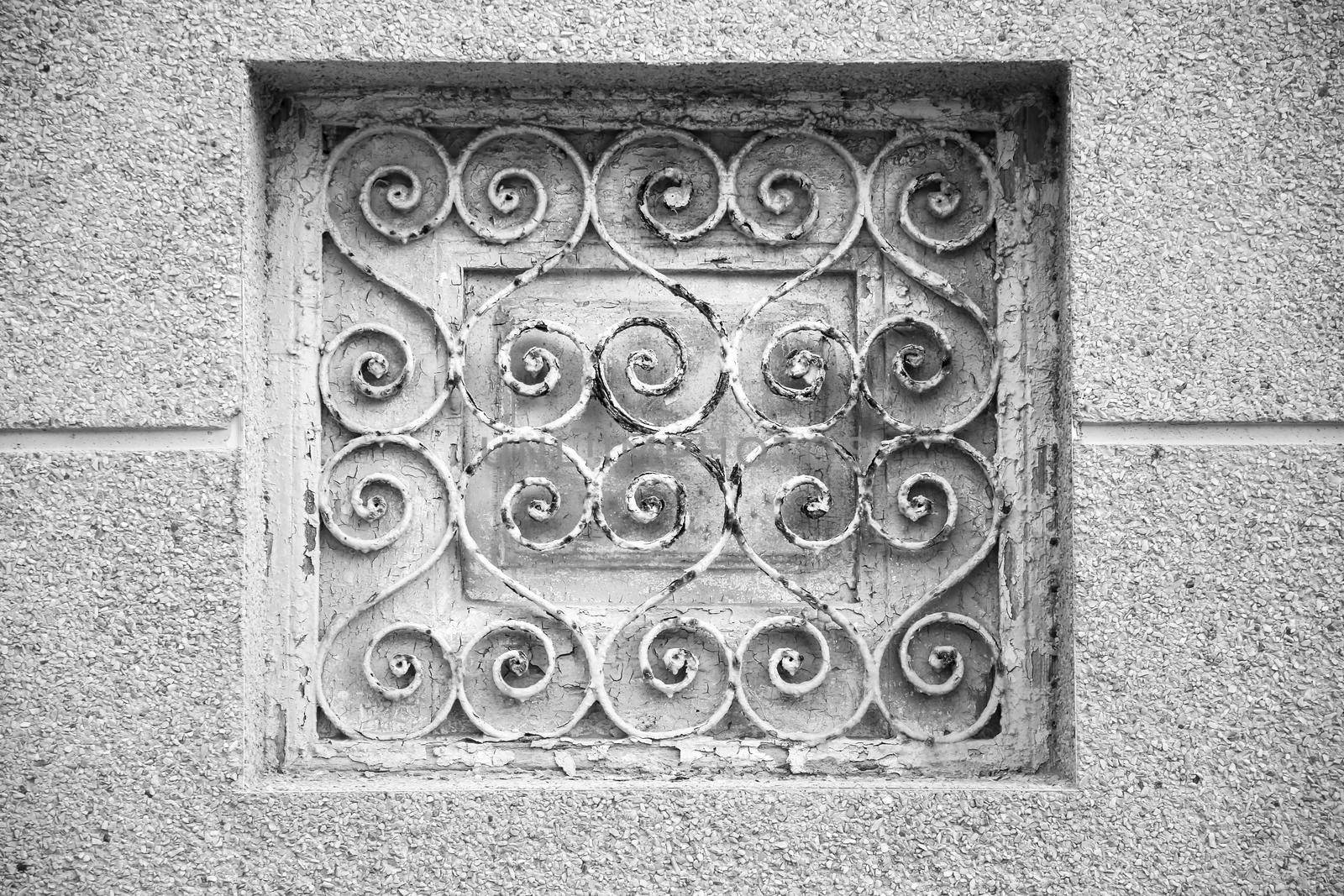 Old rusty metal grate in old building in Spain