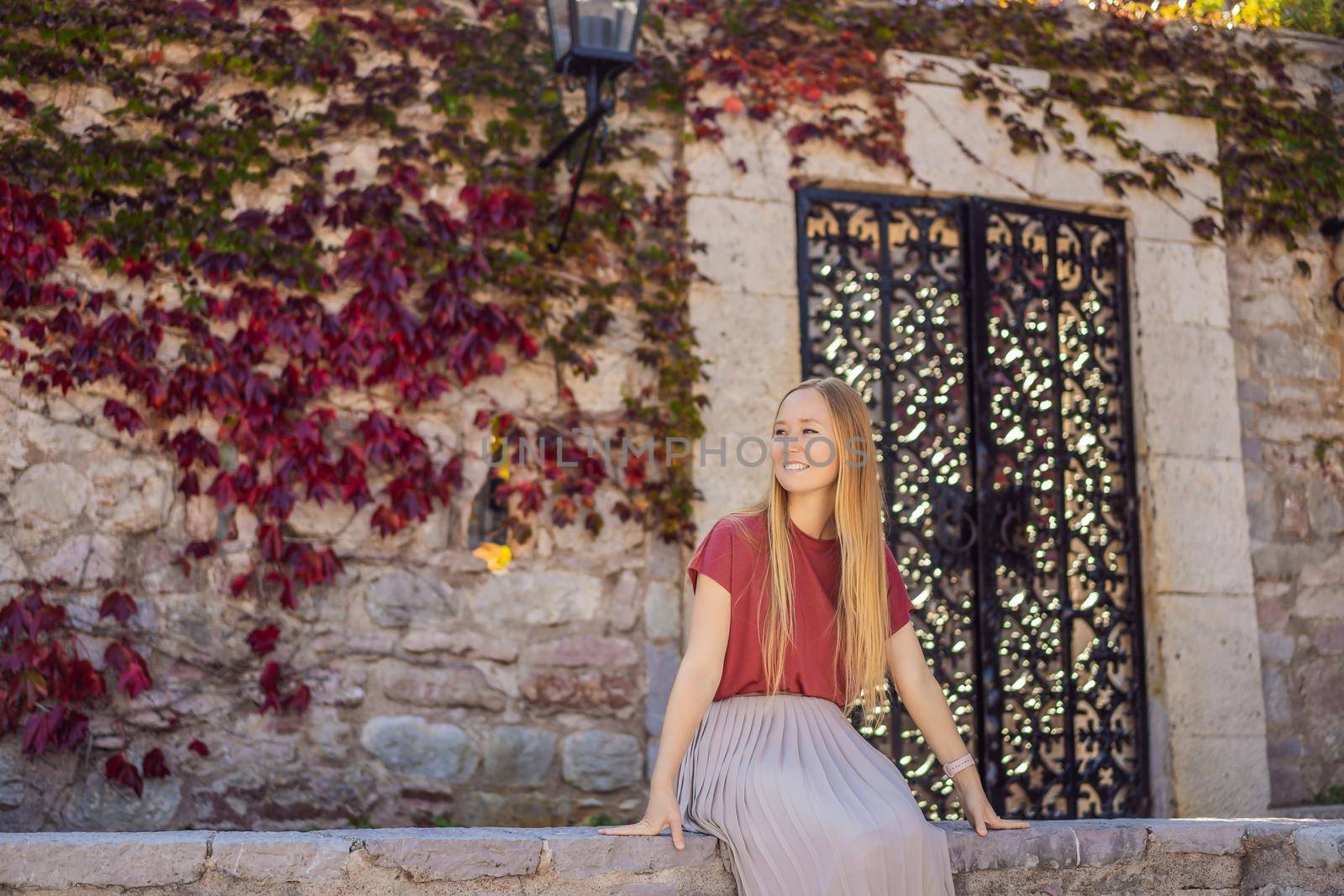 Woman tourist on background of beautiful view of the island of St. Stephen, Sveti Stefan on the Budva Riviera, Budva, Montenegro. Travel to Montenegro concept.