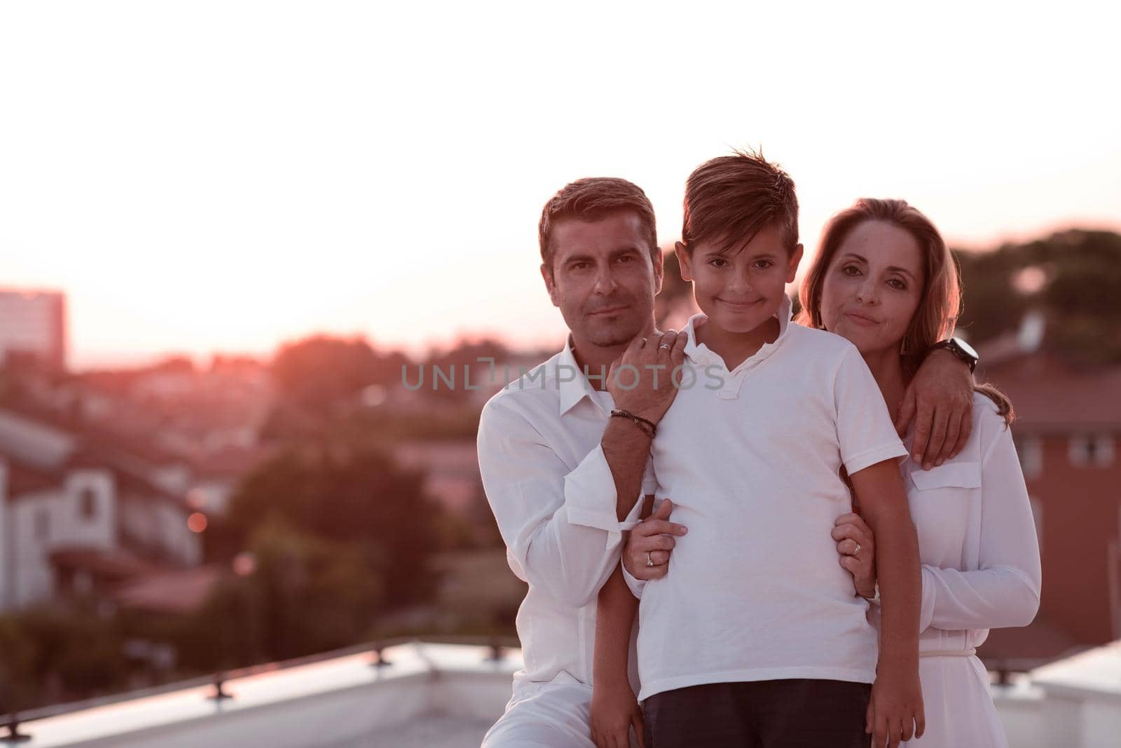 Happy family enjoys and spends time together on the roof of the house. Selective focus by dotshock