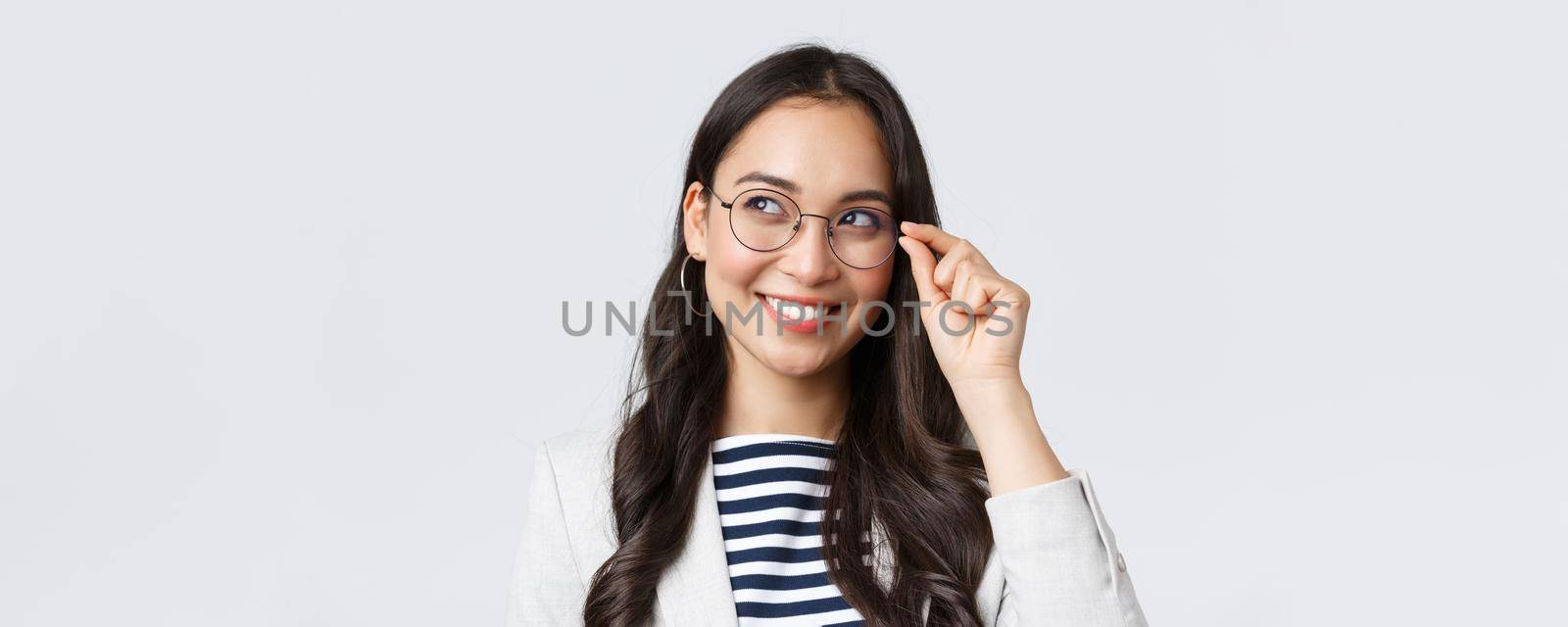 Business, finance and employment, female successful entrepreneurs concept. Close-up of dreamy and thoughtful smart asian woman, office worker in glasses, smiling and looking left by Benzoix