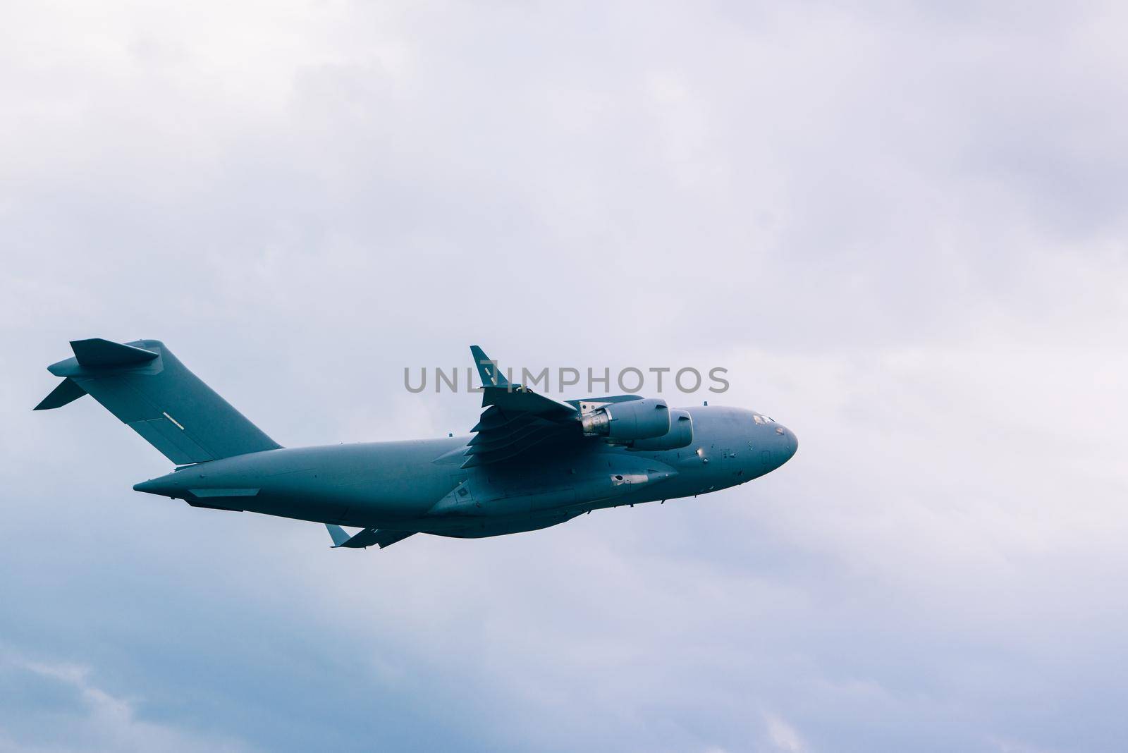 Big grey plane in a cloudy sky.