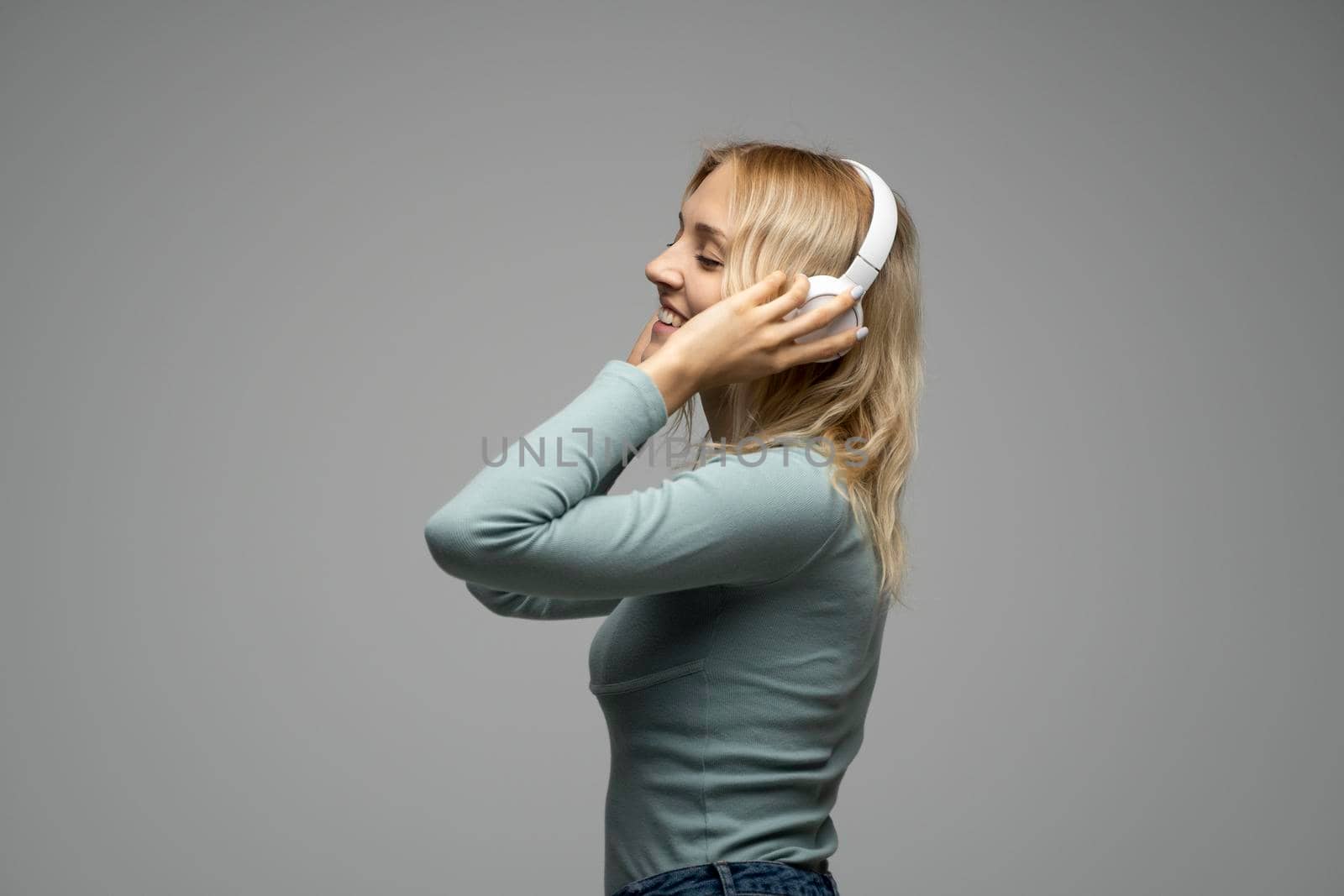 Young beautiful woman in green t-shirt enjoying a music