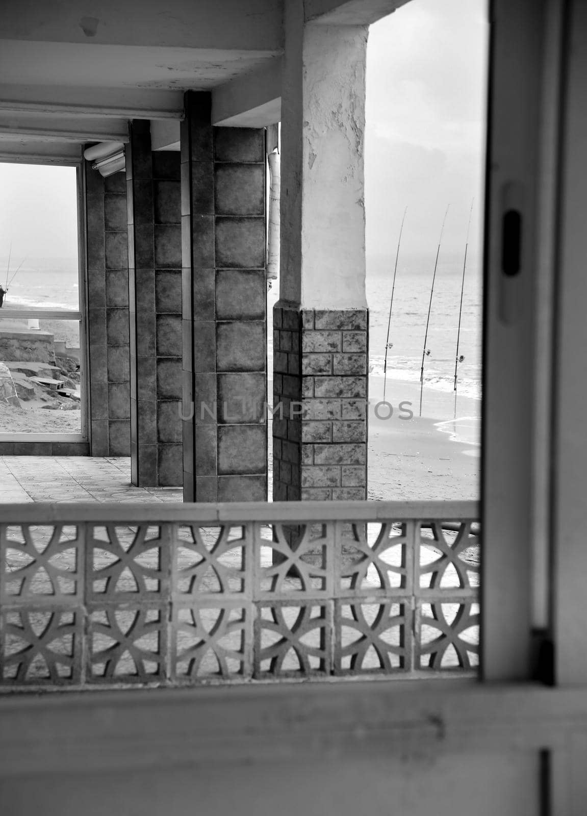 Houses on the shore in El Pinet beach ,Alicante, Spain. Fishing rods in the background. Monochrome picture.