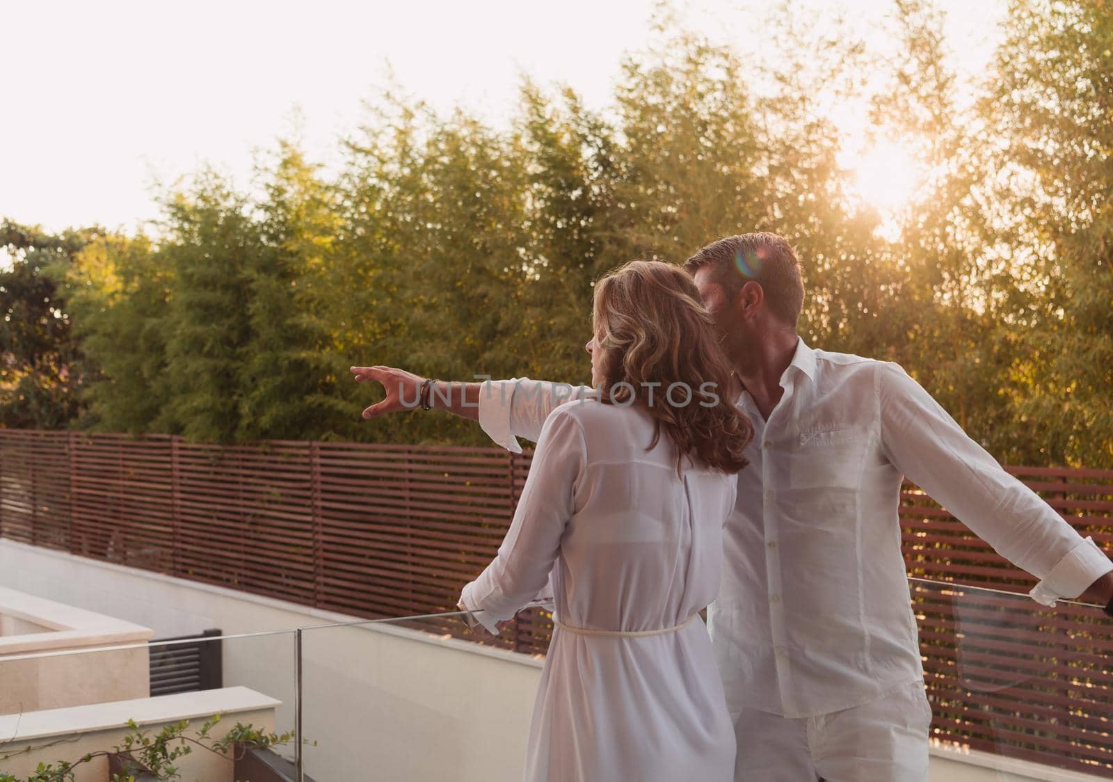 Senior couple enjoys on the terrace of a luxury house during the holidays. Selective focus by dotshock
