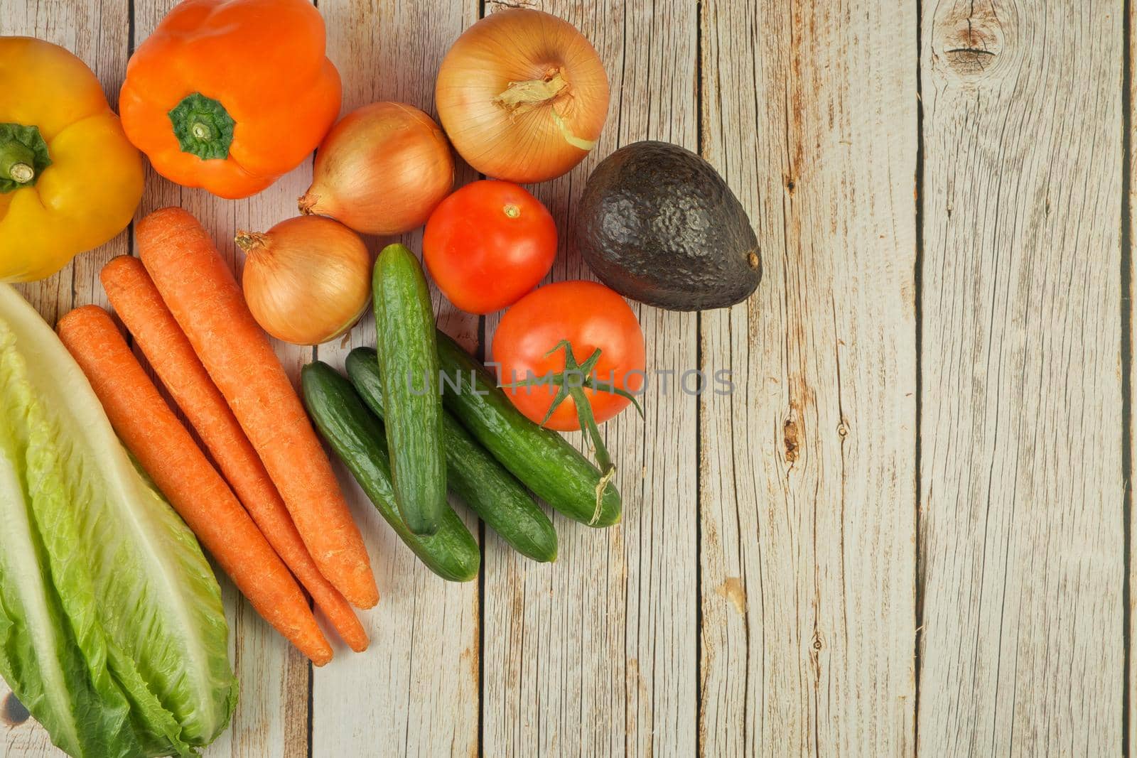 Directly Above Flat Lay View of a Variety of Fresh Summer Garden Vegetables on a Rustic Wooden Table with Copy Space on Right