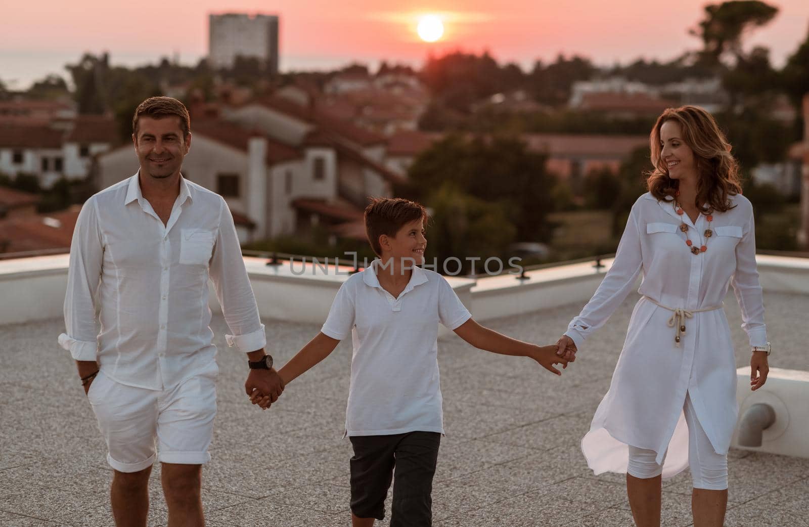 Happy family enjoys and spends time together on the roof of the house. Selective focus by dotshock