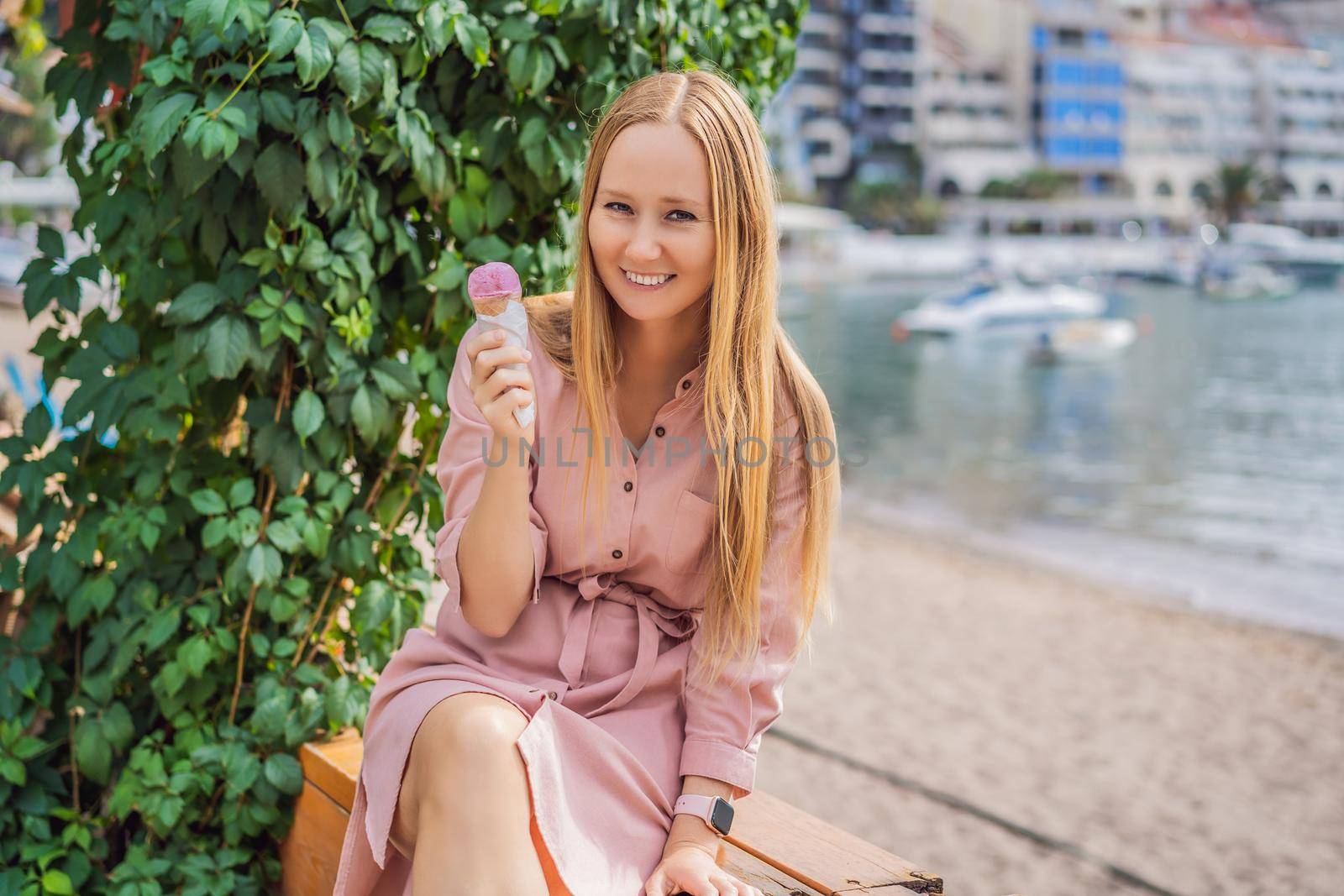 Close up of pretty tourist girl eating traditional gelato italian ice cream in a European town by galitskaya