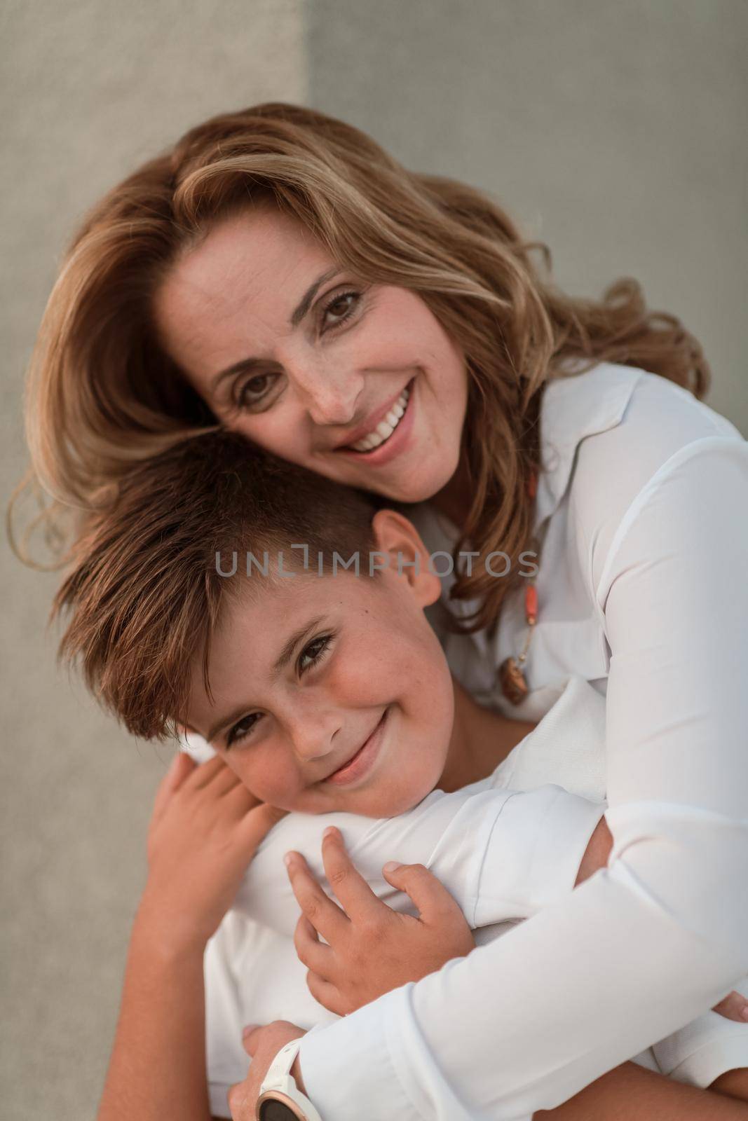 A portrait photo of an older woman in an embrace with her young son. Selective focus by dotshock