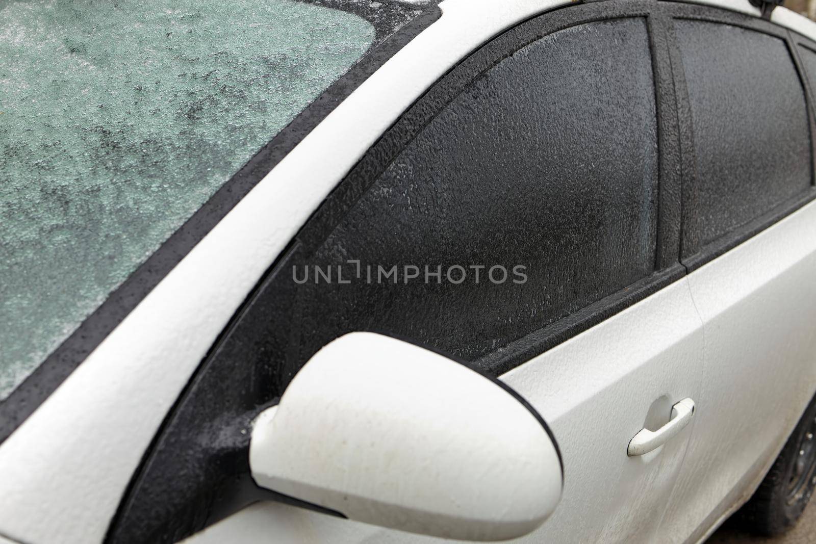 Freezing Rain Creates a Layer of Ice and Coats a Passenger Vehicle. Close up of Windshield and Doors. High quality photo