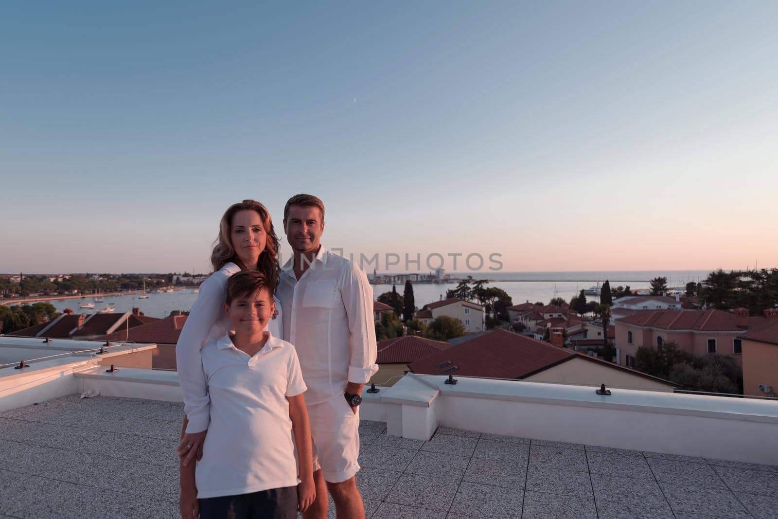 The happy family enjoys and spends time together on the roof of the house. Selective focus. High-quality photo