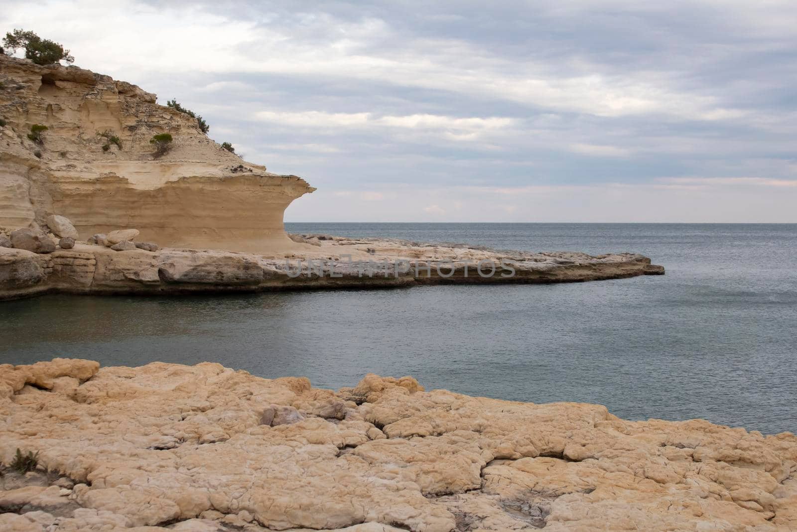 beautiful rock sea shore in spring, cloudy weather, empty beach