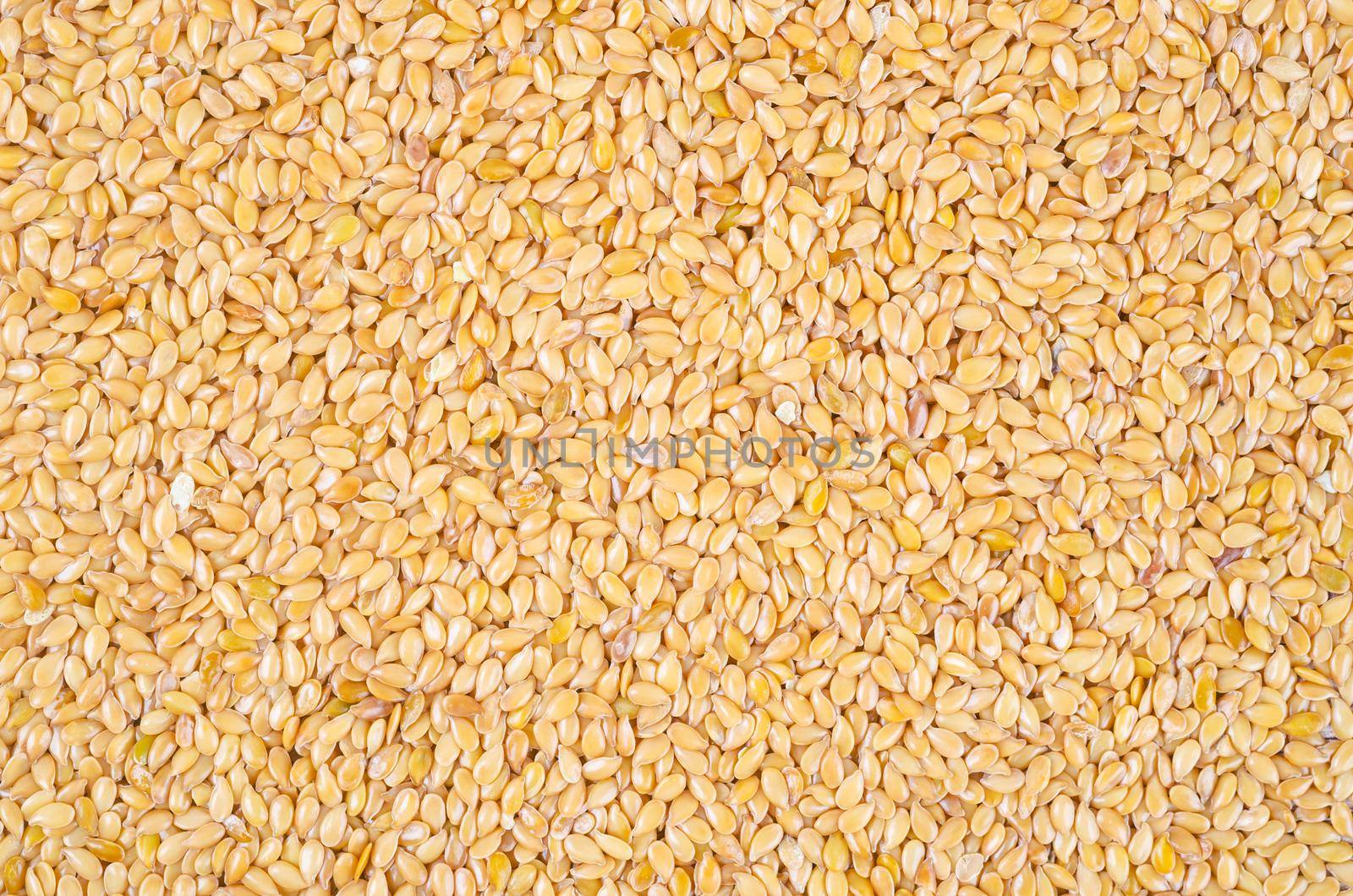 The Gold flax seeds texture as background.