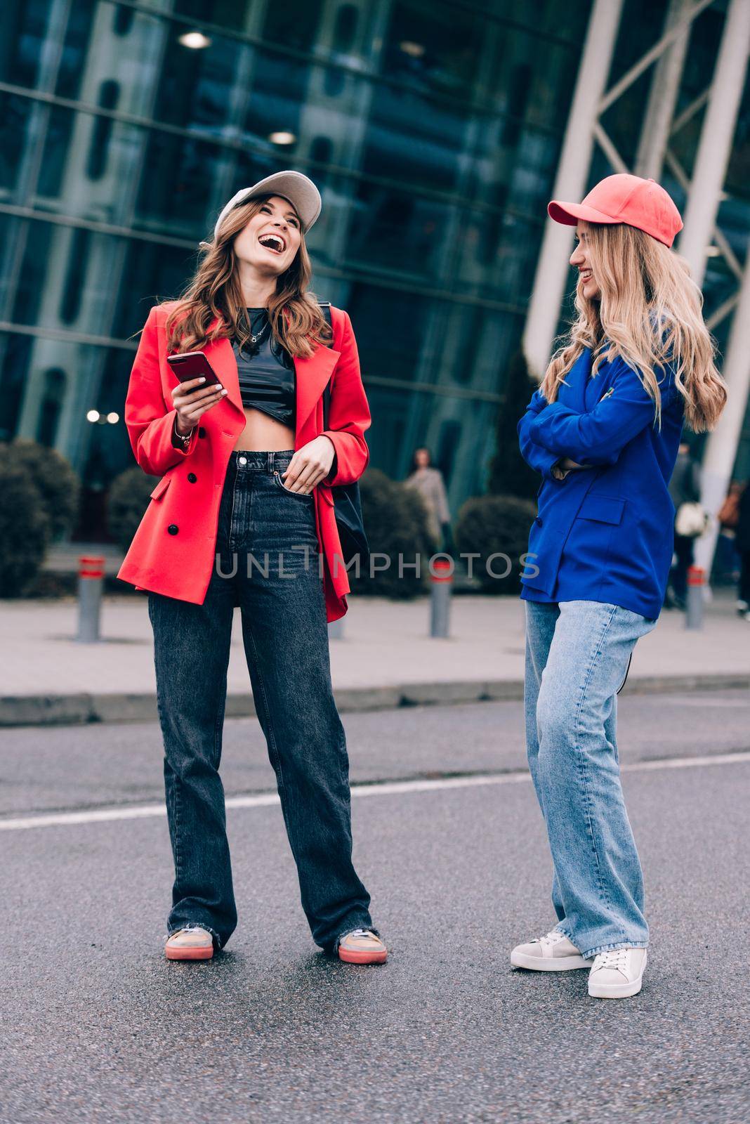 Two happy girls walking near airport. Air travel, summer holiday. Communication