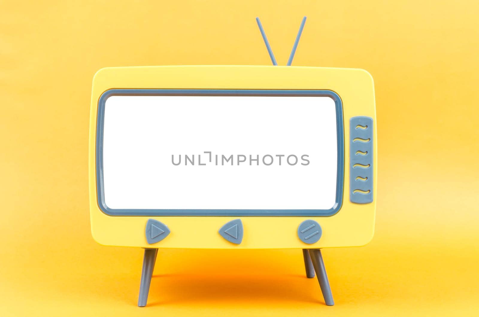 The Vintage Miniature Toy Television on yellow background.