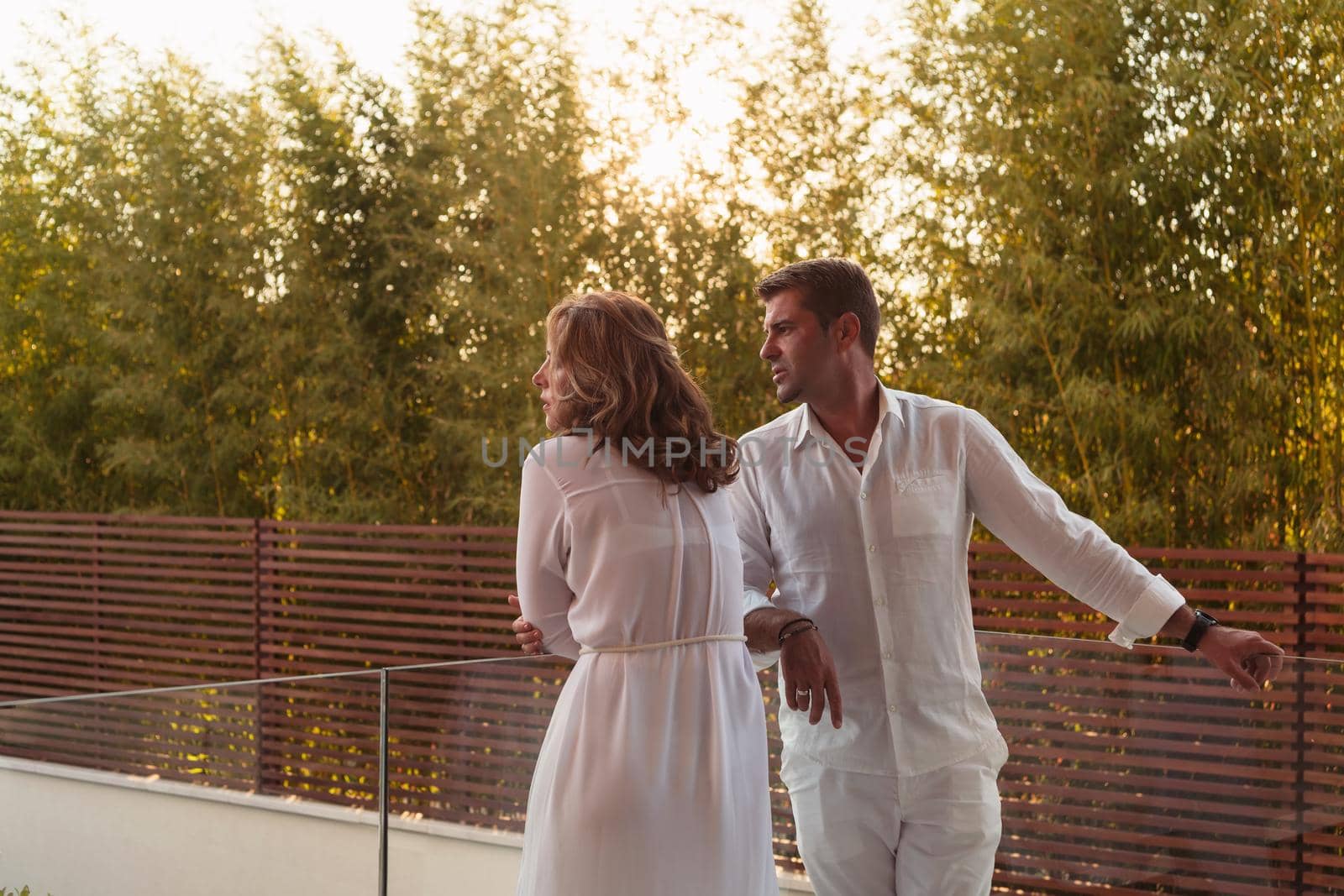 The senior couple enjoys on the terrace of a luxury house during the holidays. Selective focus. High-quality photo
