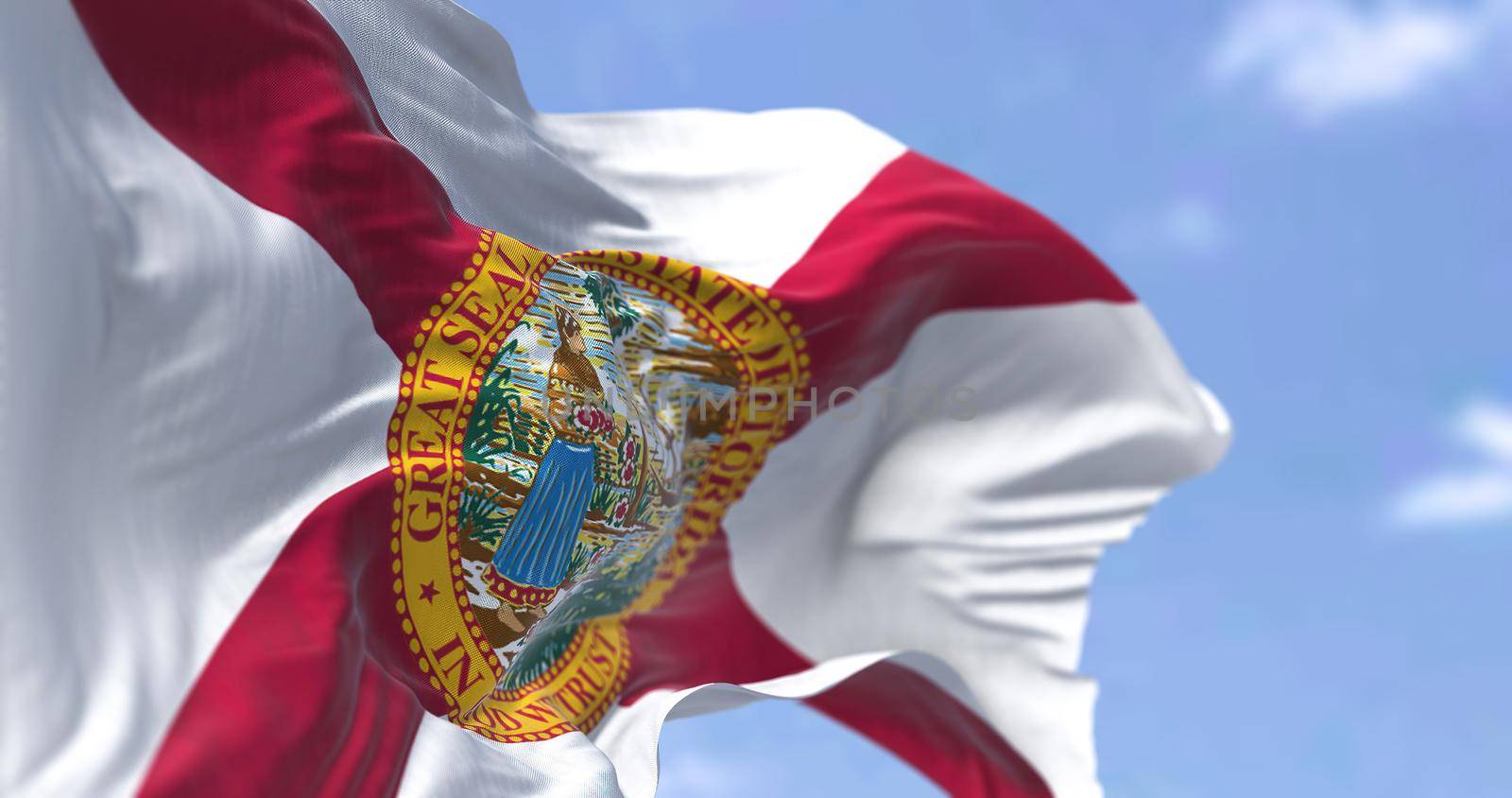 The state flag of Florida waving in the wind. Florida is a state located in the Southeastern region of the United States. Democracy and independence.