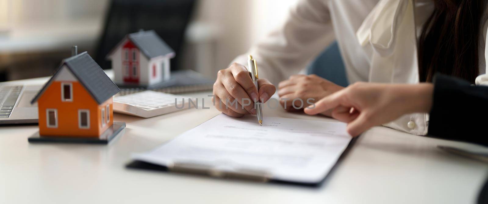 Real estate agent offer hand for customer sign agreement contract signature for buy or sell house. Real estate concept contact agreement concept by nateemee