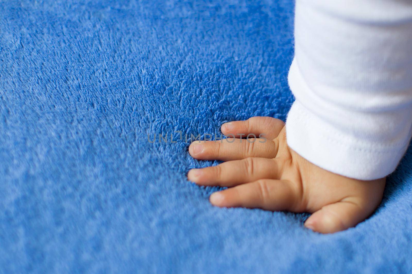 Child's hand on a blue veil,full hd video