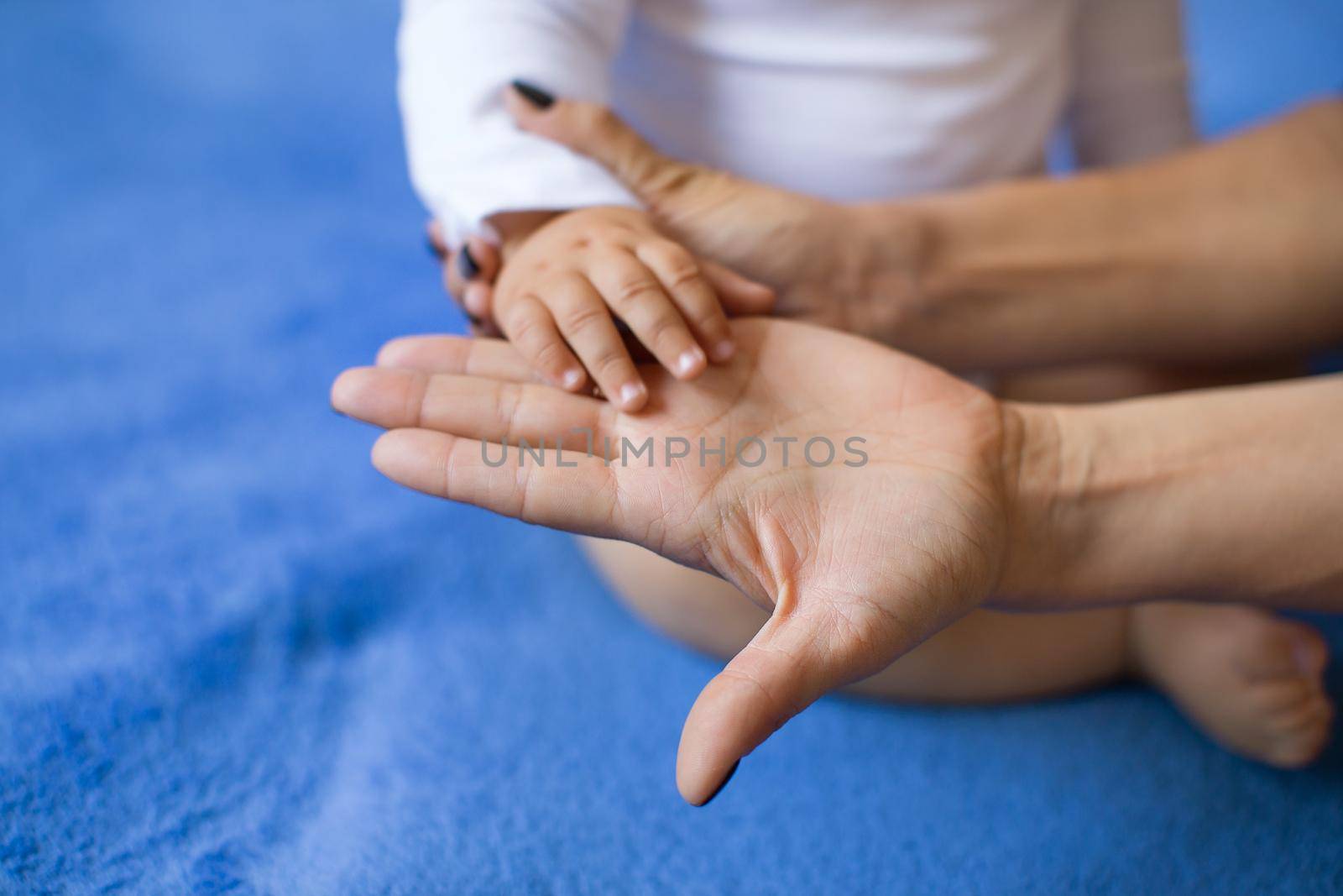 Hand of a child on a woman's palm