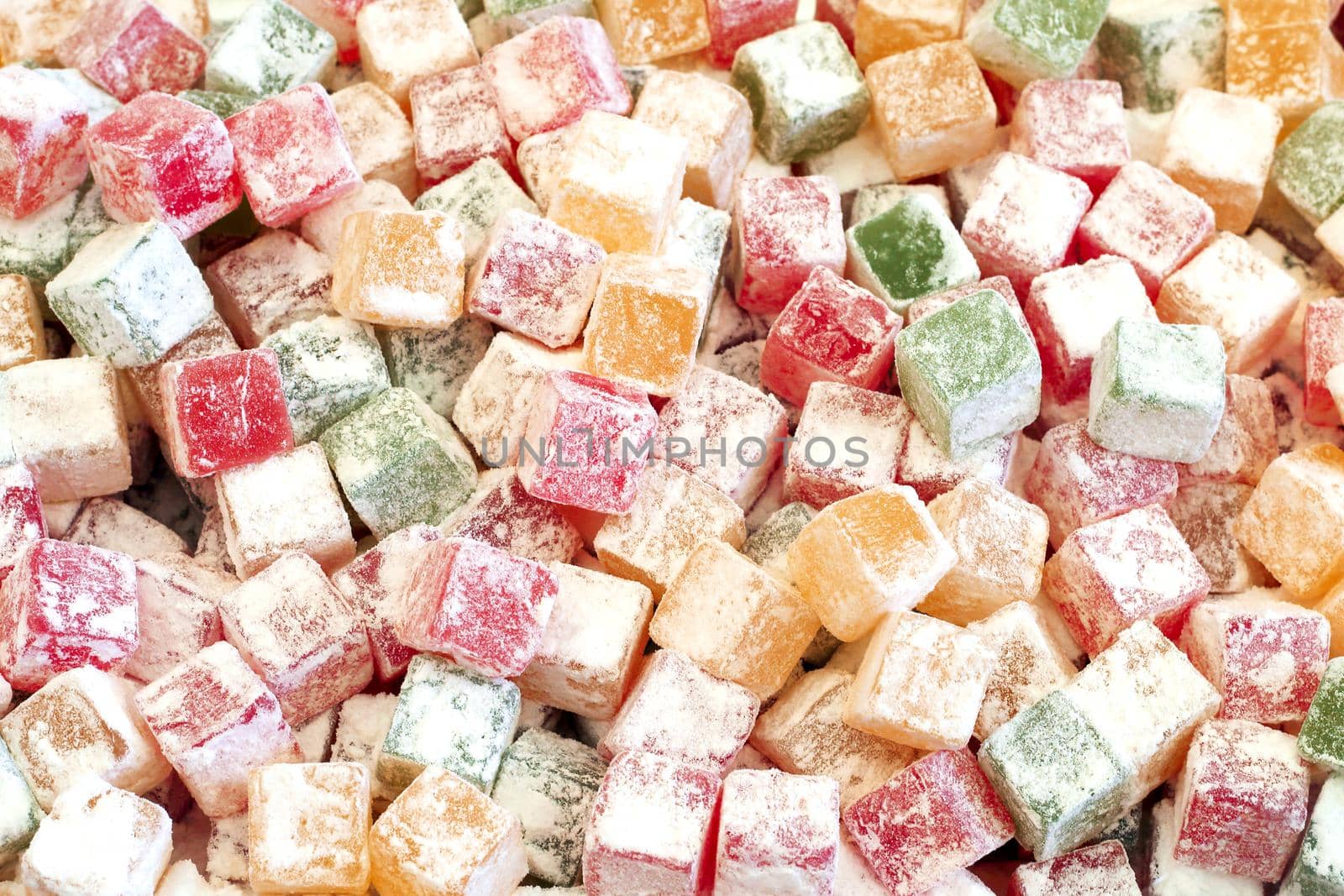 fruit paste sugar covered different colors candy background, top view