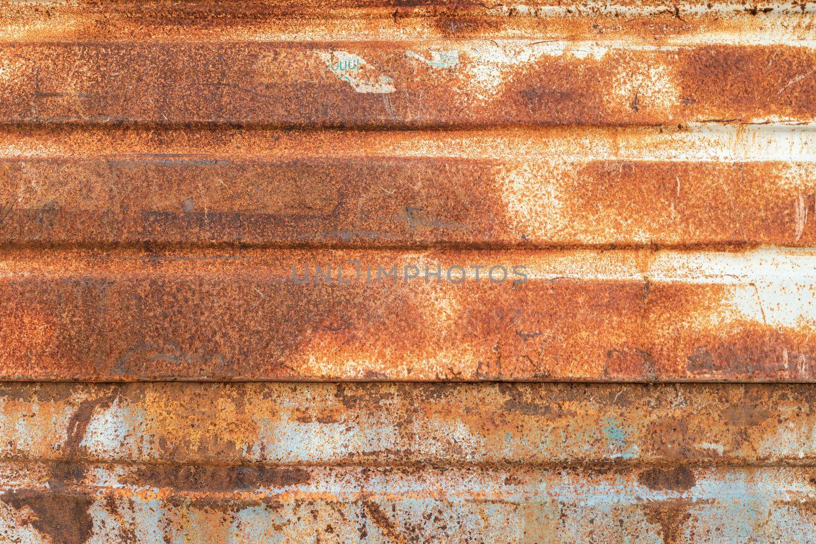 Old rusty metal background heavily aged and corroded. The corrosion stain creates a grungy frame.