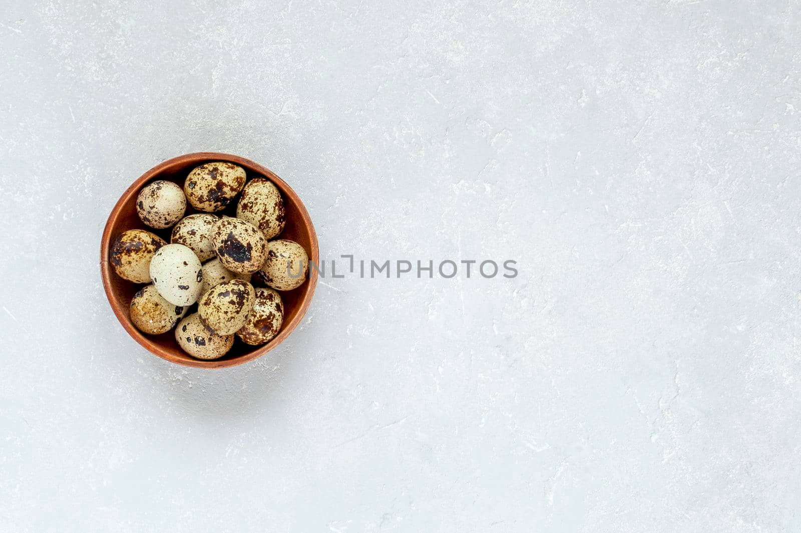 small round wooden bowl of quial eggs, minimalism, top view, copy space