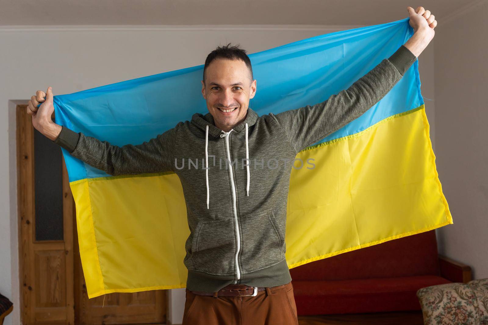 Happy young man with Ukrainian flag