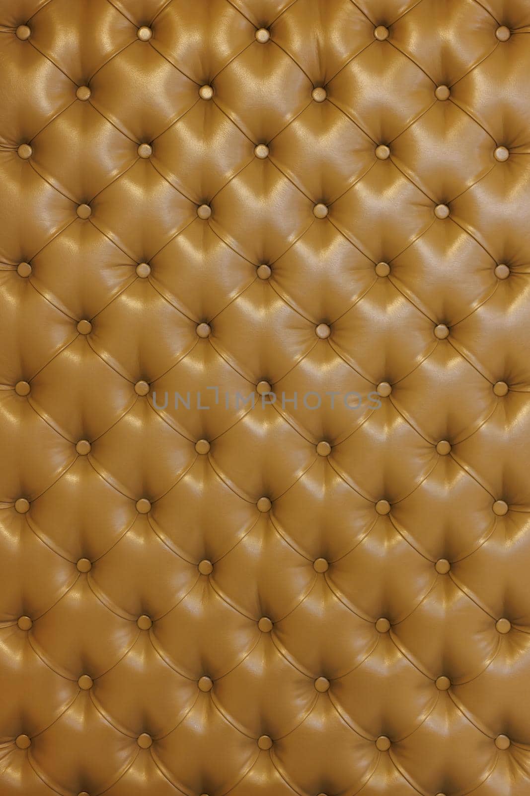Texture of brown beige leather background with capitone pattern, full-frame. Brown retro Chesterfield style. Vintage furniture backdrop.