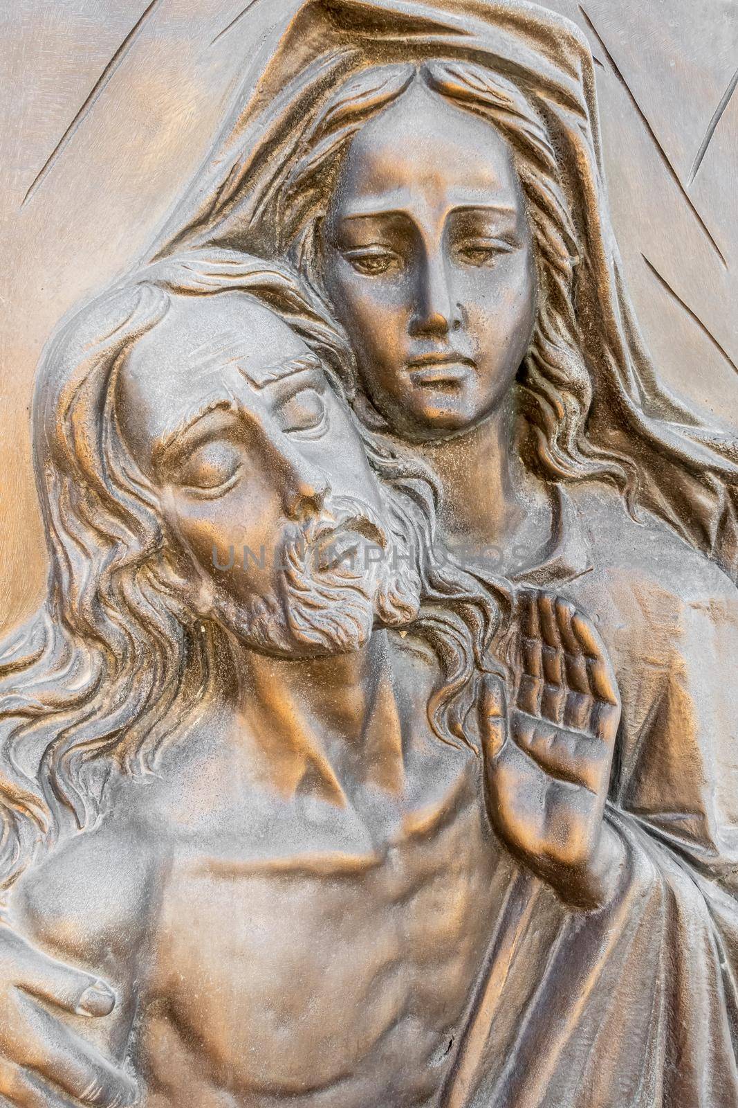Bas-relief in bronze representing The Pity of Michelangelo. Faces of Holy Mary mother and Jesus Christ after the Crucifixion.