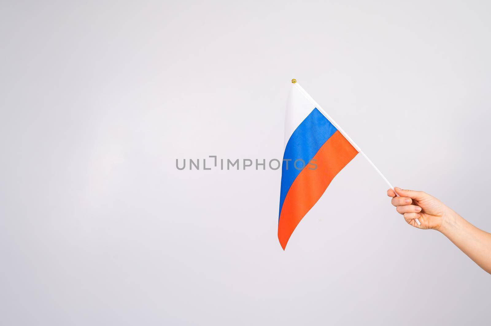 Woman holding a small flag of the Russian Federation on a white background. by mrwed54
