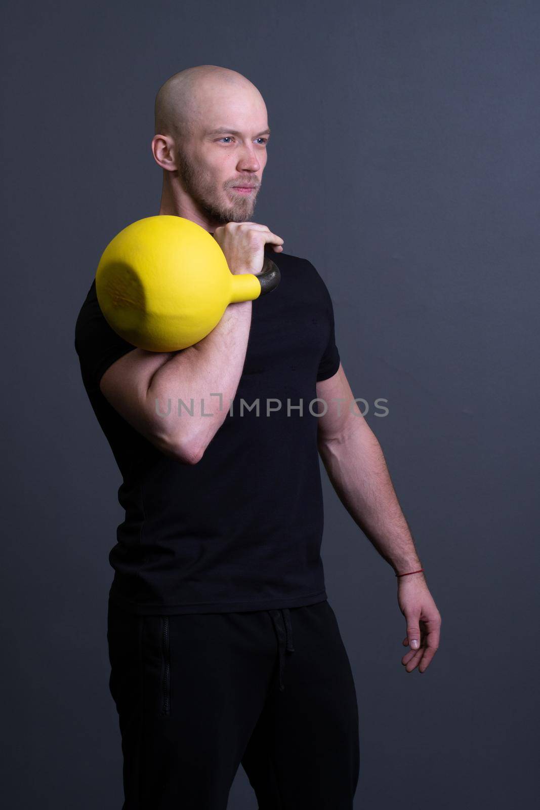 Guy with a yellow kettlebell gym anonymous young strength, for sporty lifestyle for strong and floor sportswear, vietnamese filipino. Healthy down endurance, building hiit by 89167702191