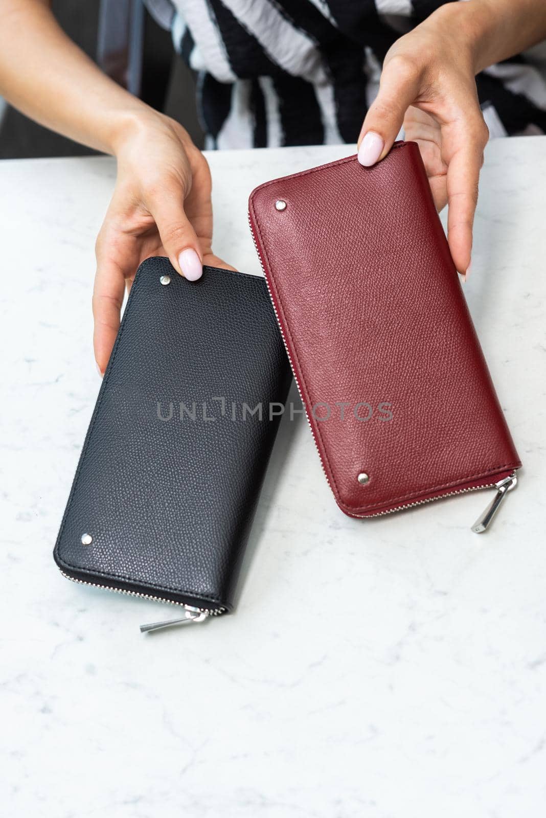 Two wallets in the hands of a girl