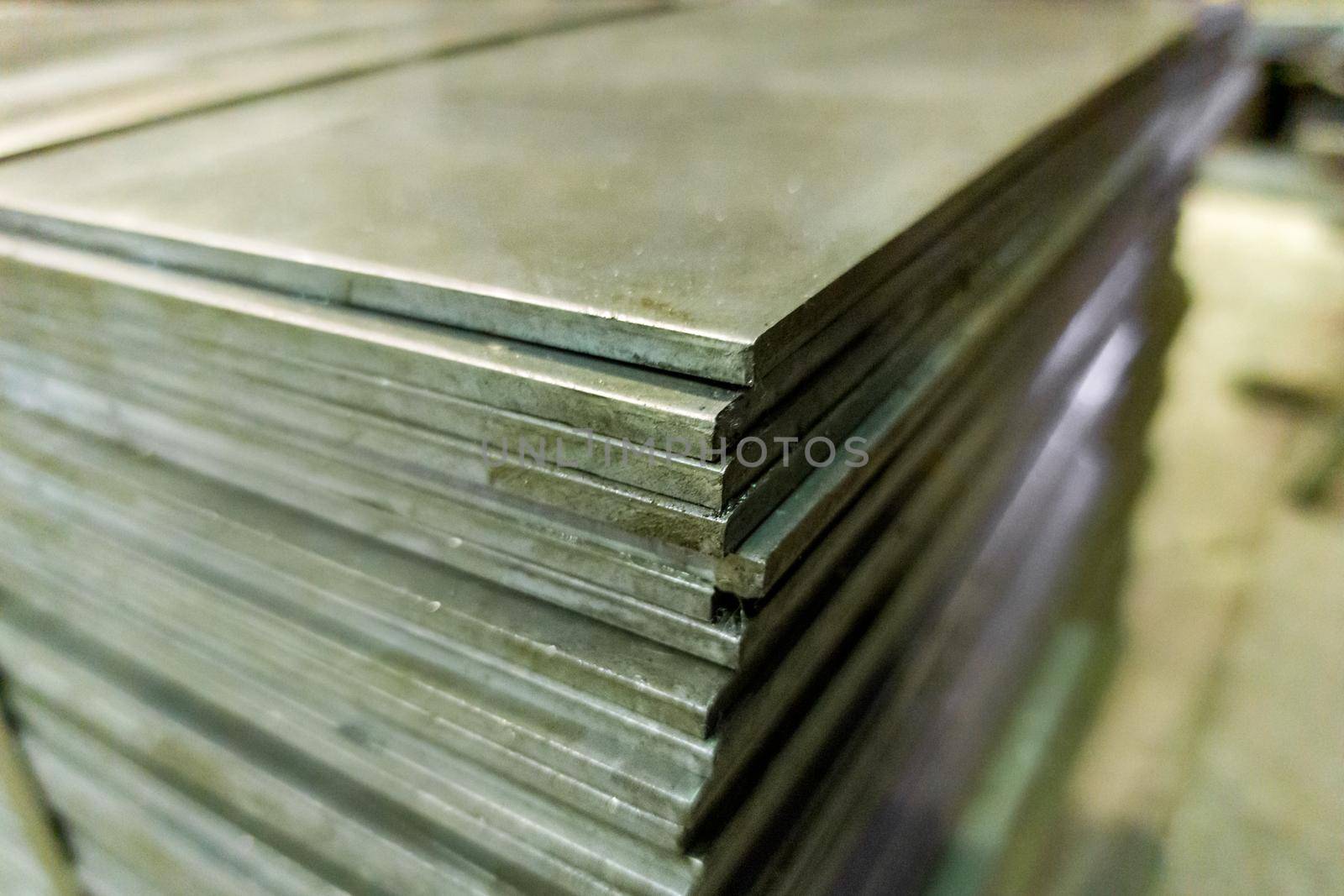 stack of mild steel sheets, full-frame close-up view with selective focus, industrial material background