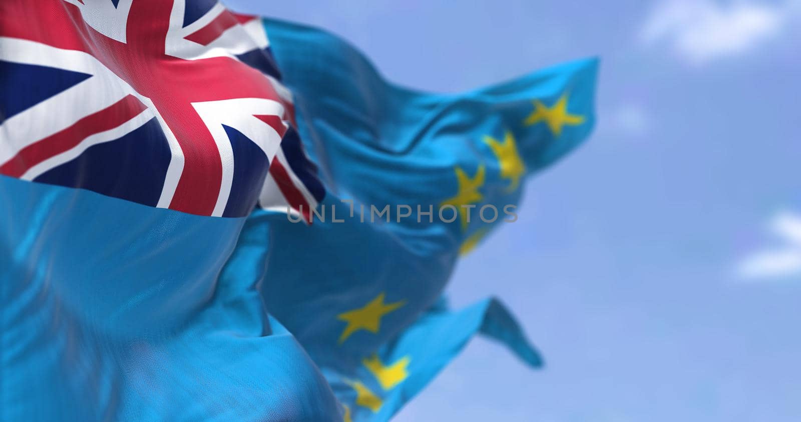 Detail of the national flag of Tuvalu waving in the wind on a clear day. Tuvalu i is an island country in the Polynesian subregion of Oceania in the Pacific Ocean. Selective focus.