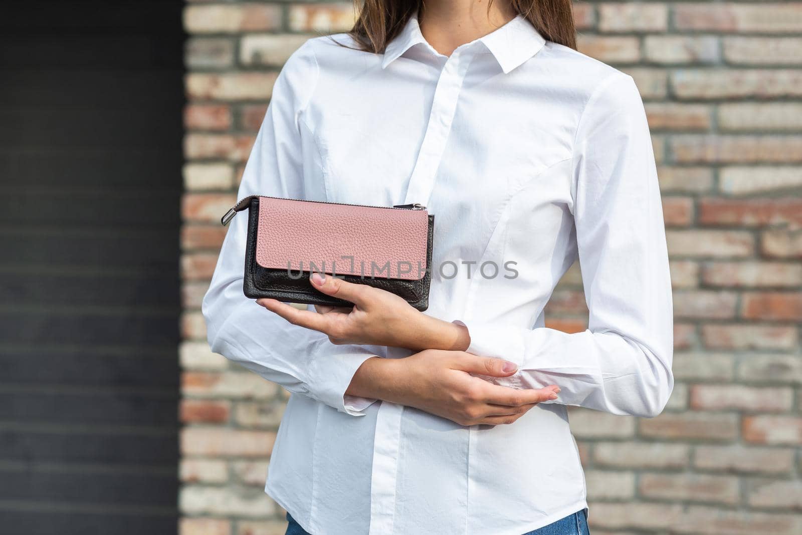 Girl in white holds a purse